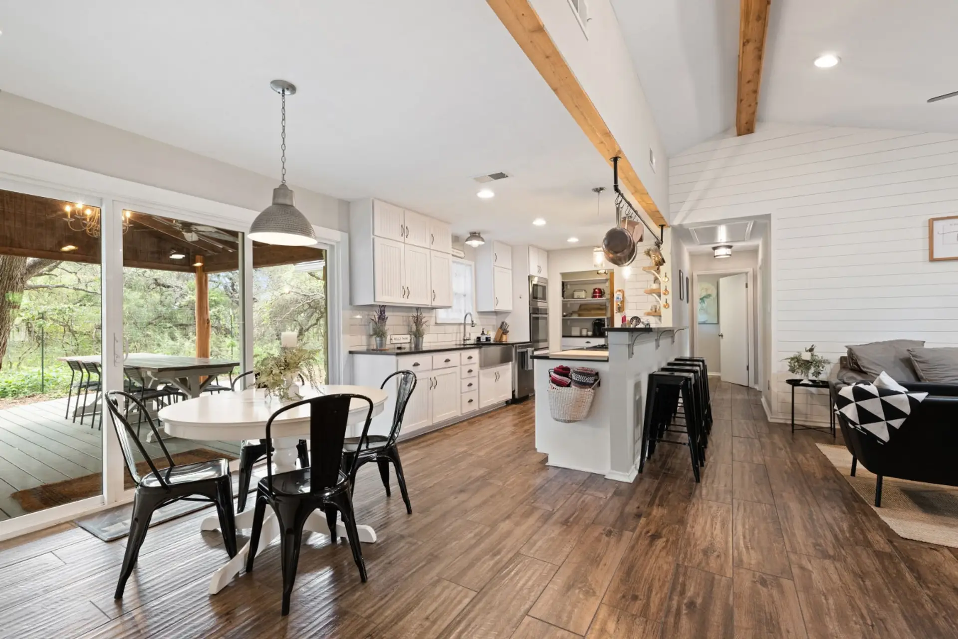 The Lazy Lavender Farmhouse in Wimberley Texas — Open Plan Kitchen and Dining with Large Windows and Natural Light