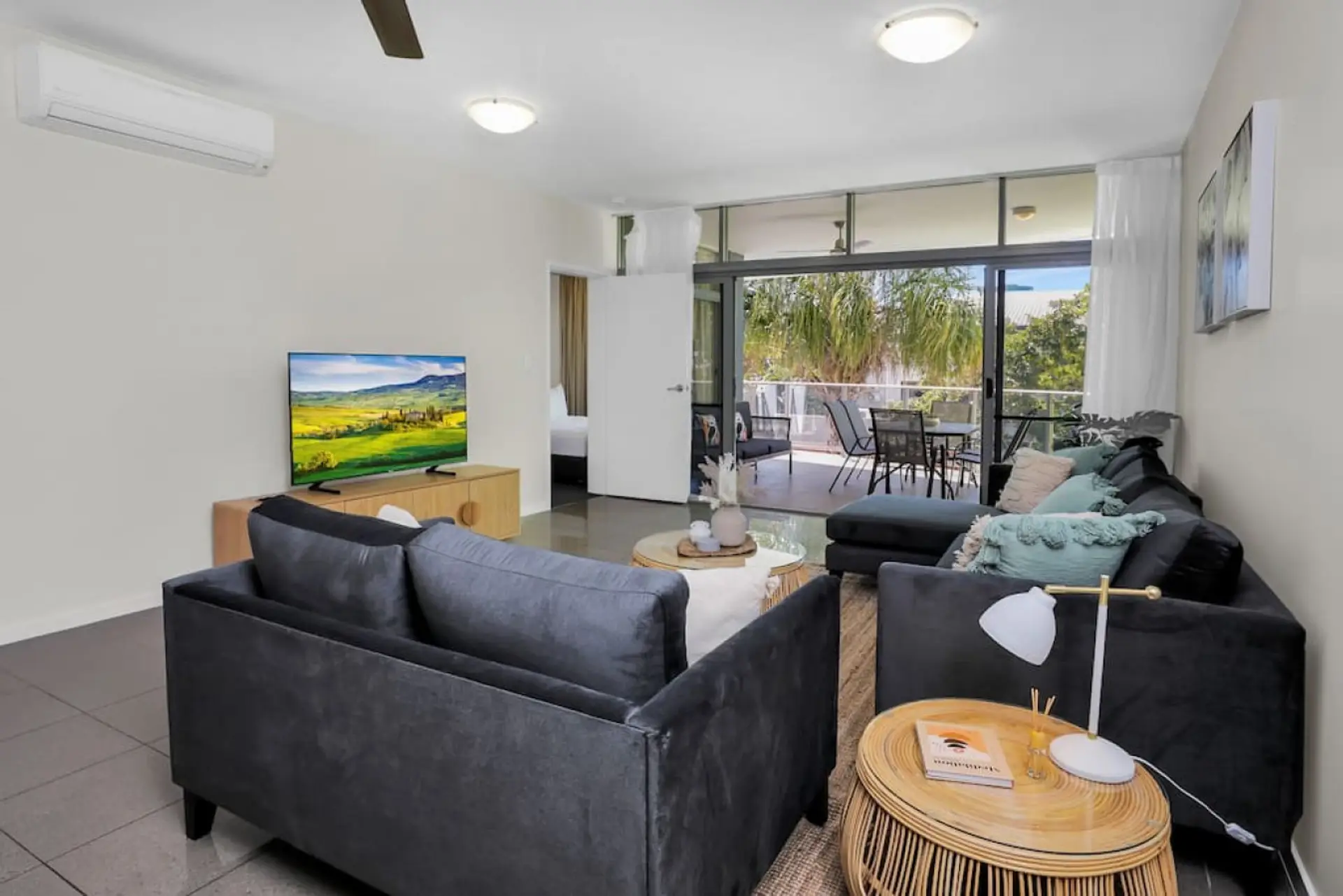 Living Room: Bright and airy with modern furnishings and a scenic patio view for ultimate relaxation!