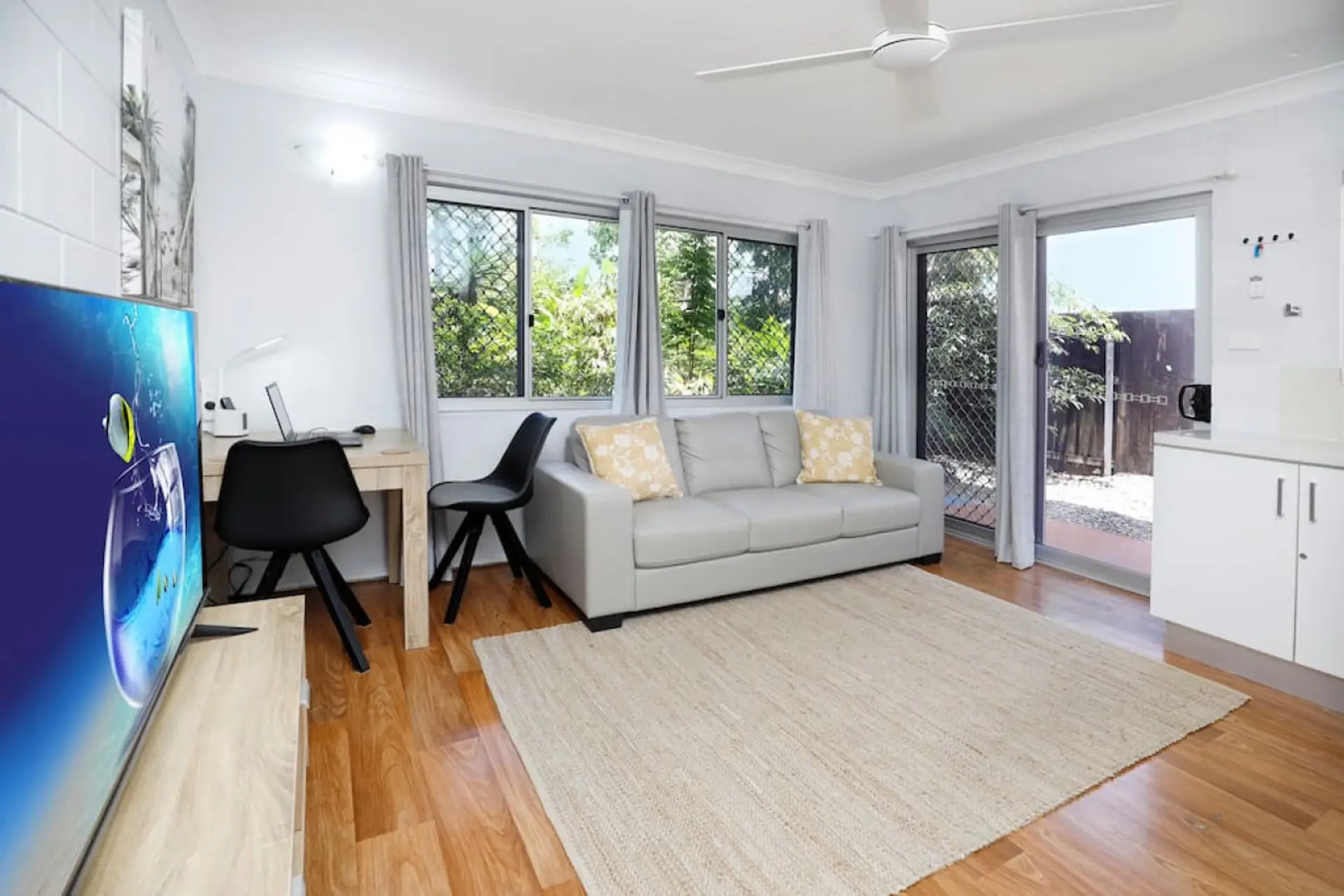 Living Room: Bright and airy space featuring modern decor, a Smart TV, and direct patio access!