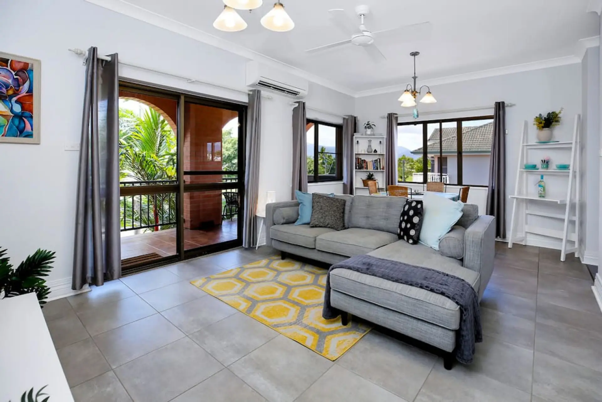 Lounge Room: Embrace the tropical breeze in this stylish lounge with balcony access! overlooking the northern end of the Cairns Esplanade