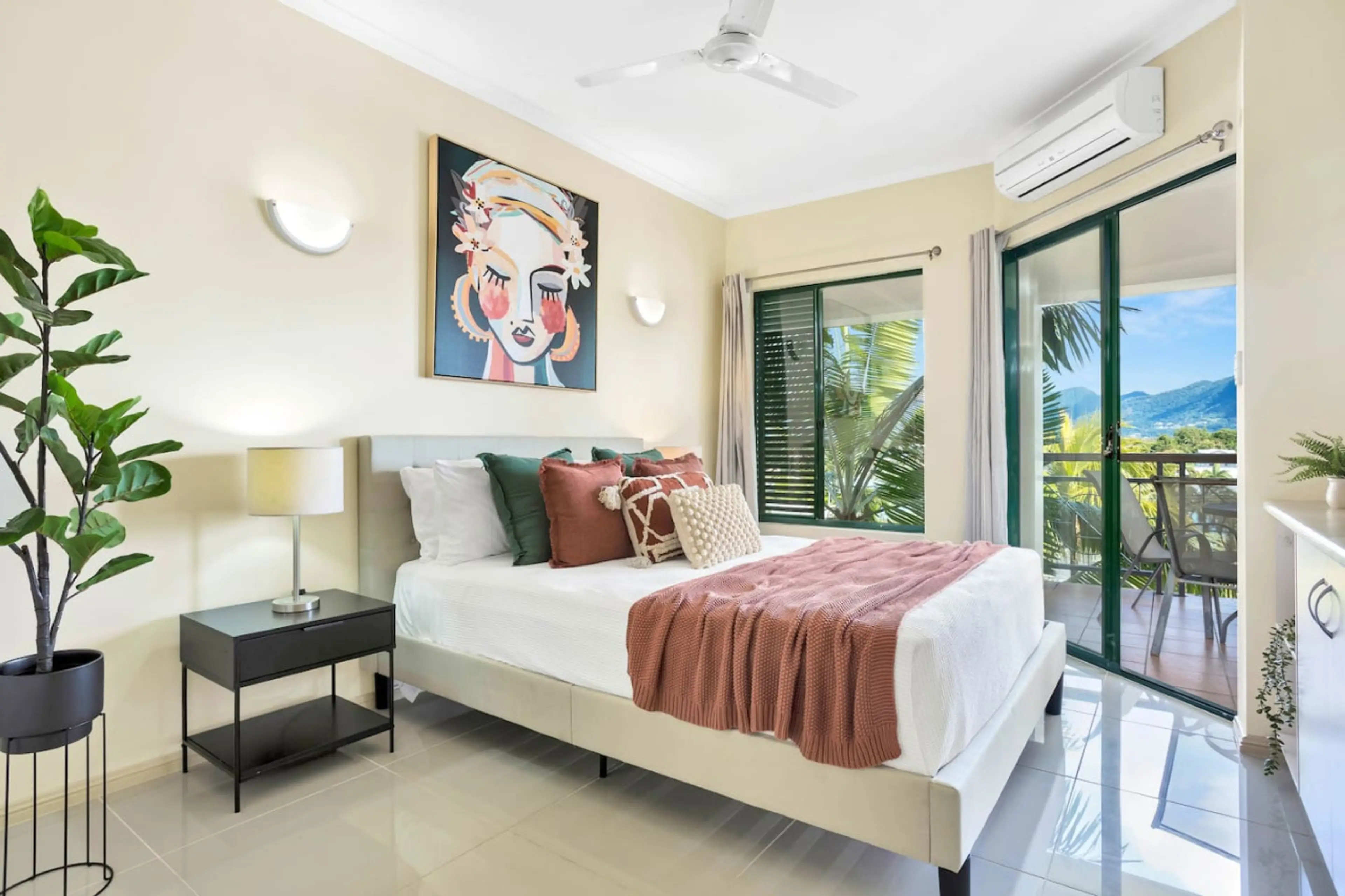 Cozy room with queen bed, air conditioning, and balcony access. Perfect for a relaxing stay.