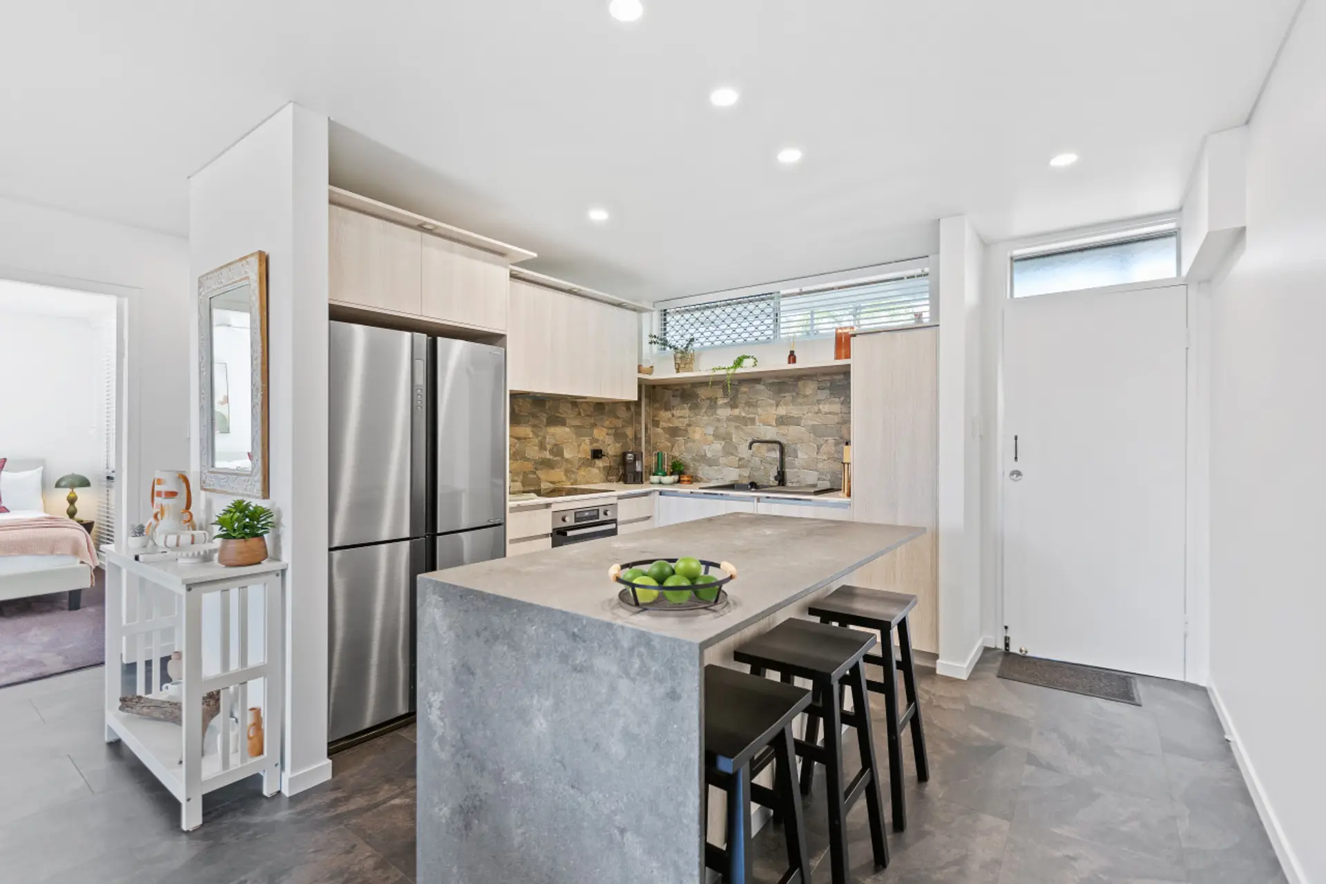 Modern Kitchen: Stylish space with stone accents and sleek appliances for culinary adventures!
