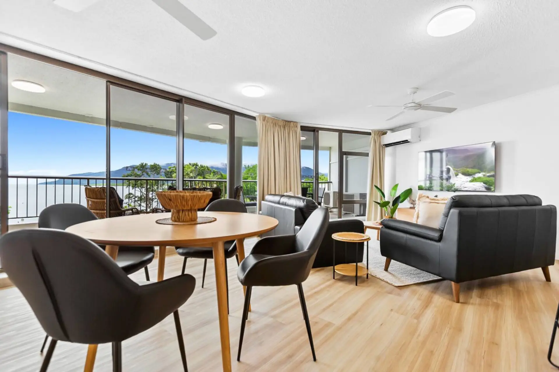 Bright and inviting living room, fully air-conditioned for year-round comfort. With sleek, modern furnishings and large windows offering stunning views, this space is designed for both relaxation and style.