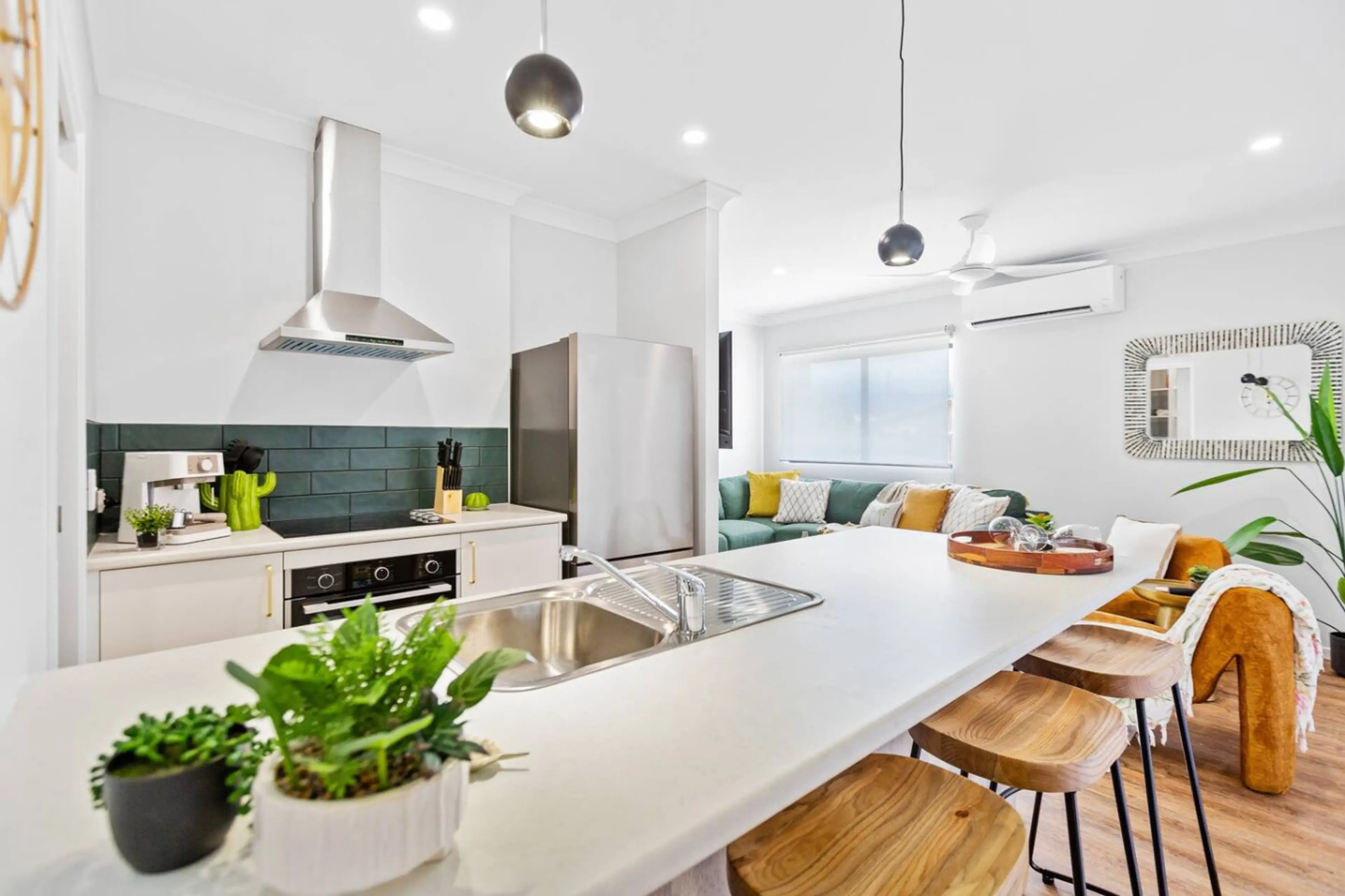 The modern kitchen is fully equipped with brand-new appliances, sleek cabinetry, and plenty of counter space. It includes a dishwasher, oven, and large fridge, offering a stylish and functional space for cooking and entertaining in comfort.
