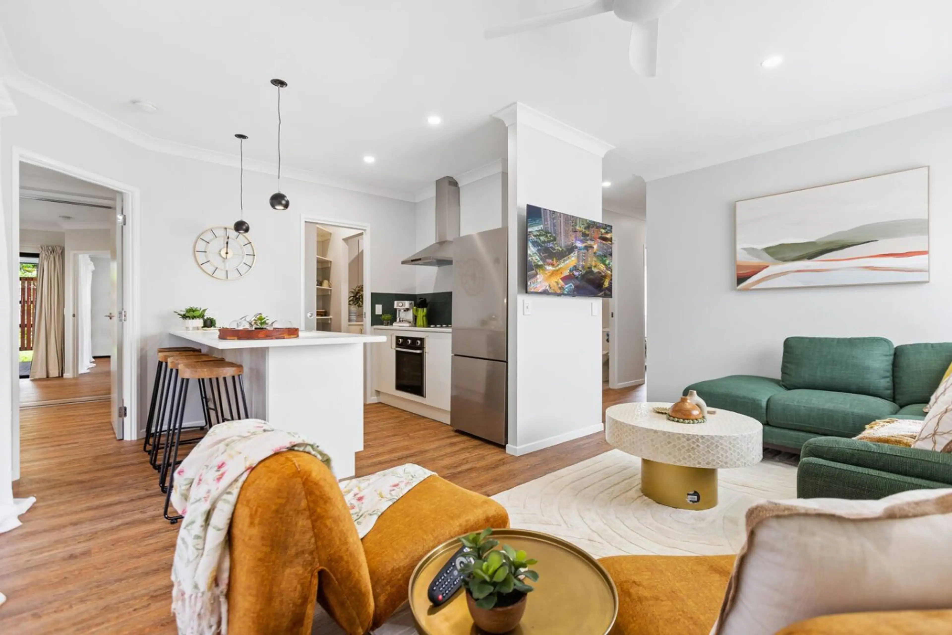 The living room is a spacious, modern haven with sleek furnishings and a relaxing atmosphere. Fully air-conditioned, it offers a comfortable retreat in any season. Large windows let in natural light, creating a bright and inviting space to unwind.