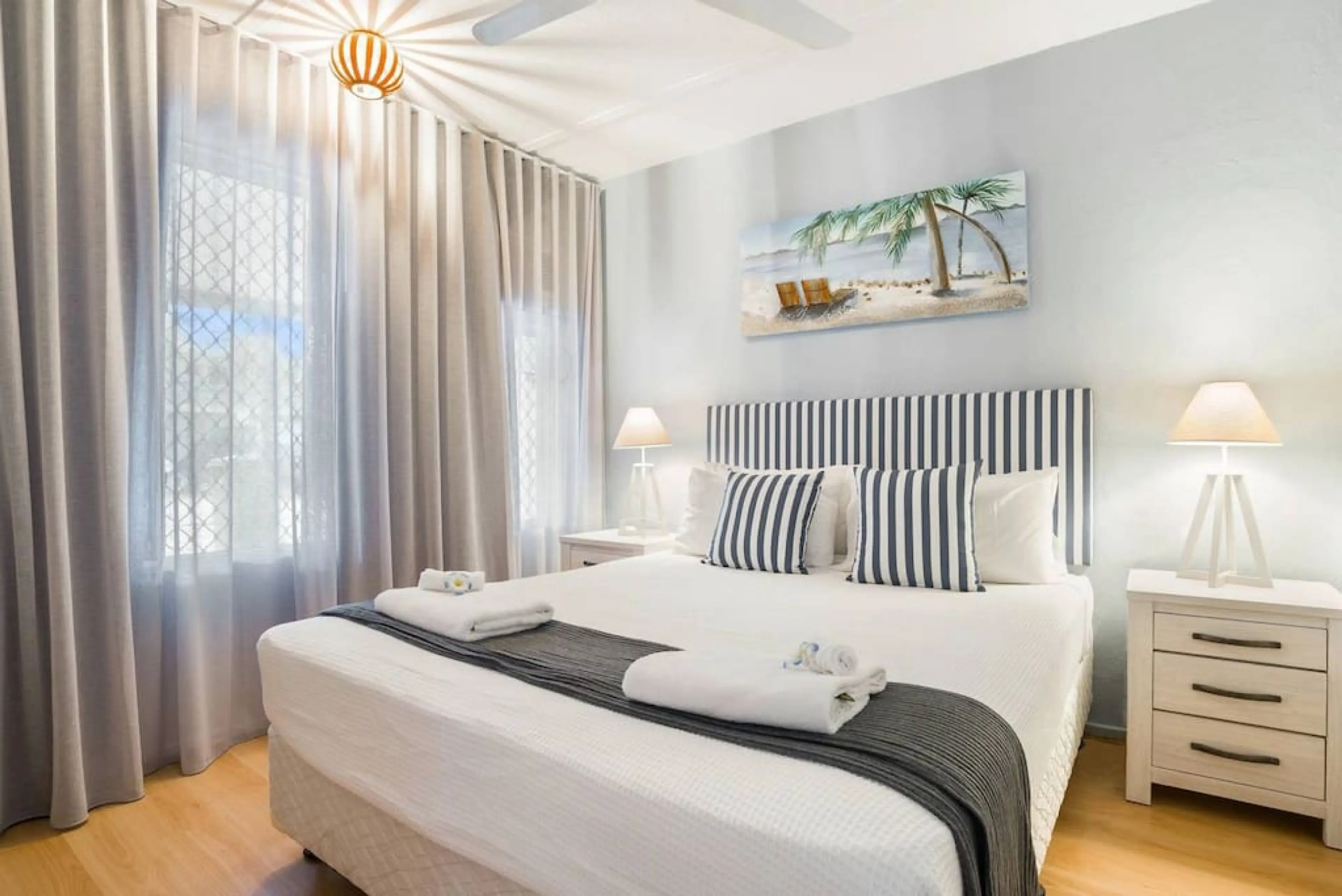 Bedroom: Stylish retreat with a queen bed, coastal decor, and sunny, uplifting ambiance