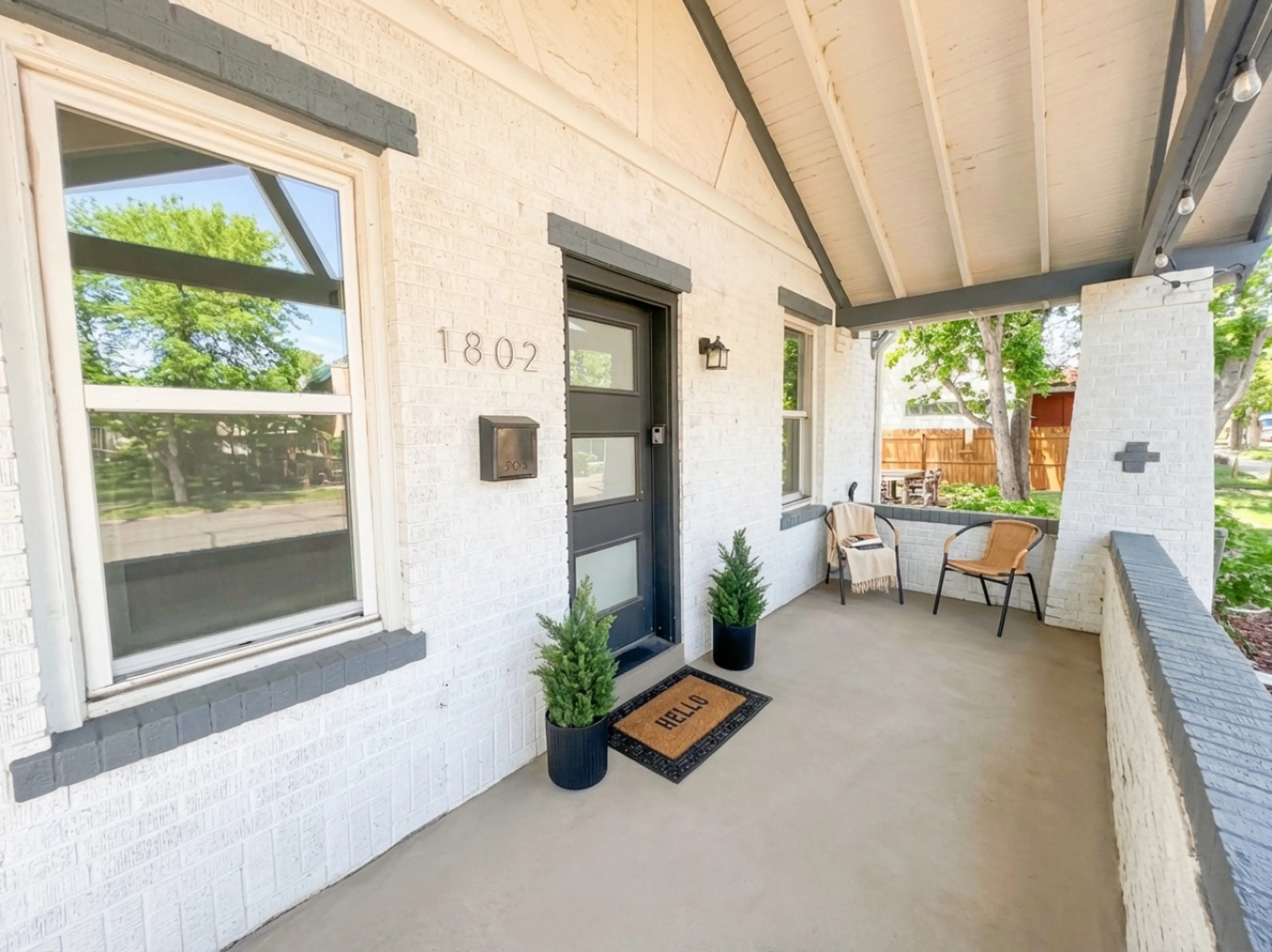 Welcoming covered porch with seating area and smart lock entry for easy self check-in