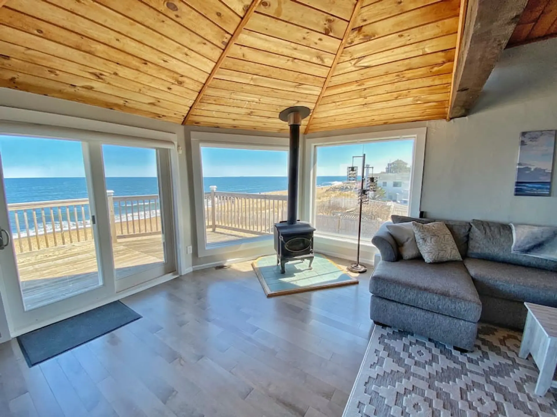 A stunning coastal living space featuring floor to ceiling views of the Atlantic Ocean.