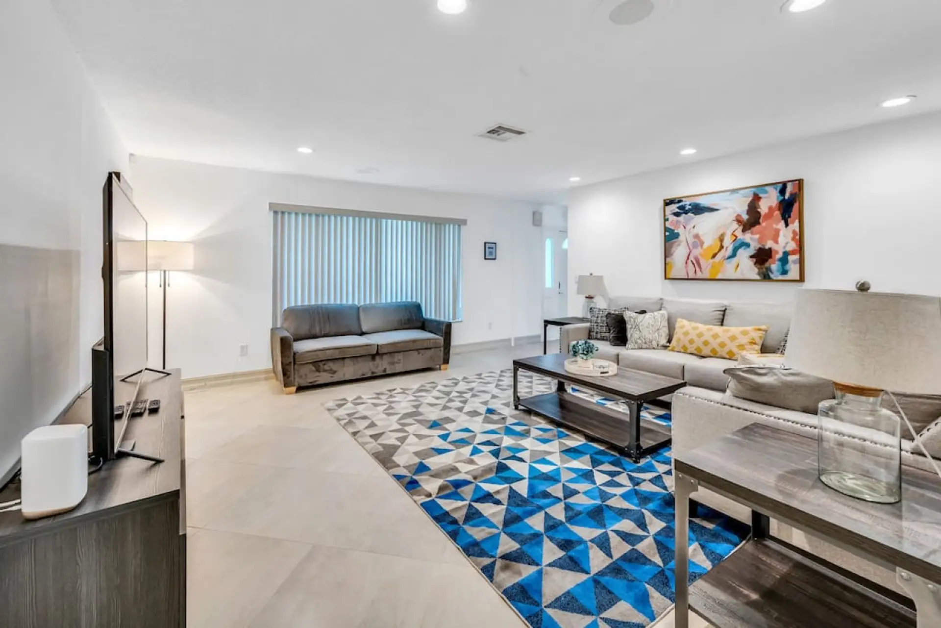 Relax in the bright and spacious living room featuring comfortable seating and modern décor.