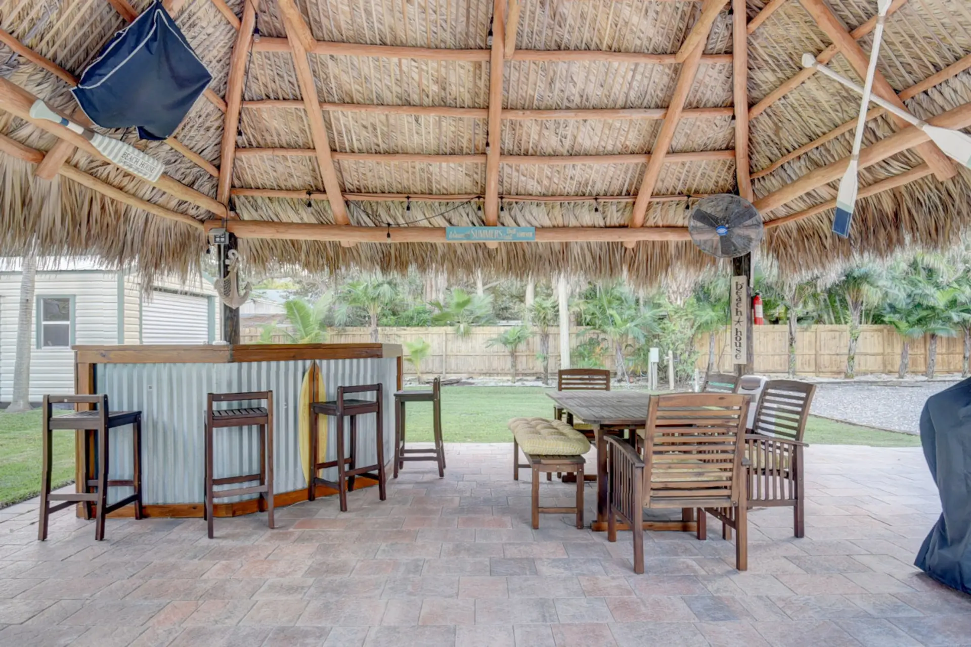 Tiki patio with built-in bar and outdoor dining.