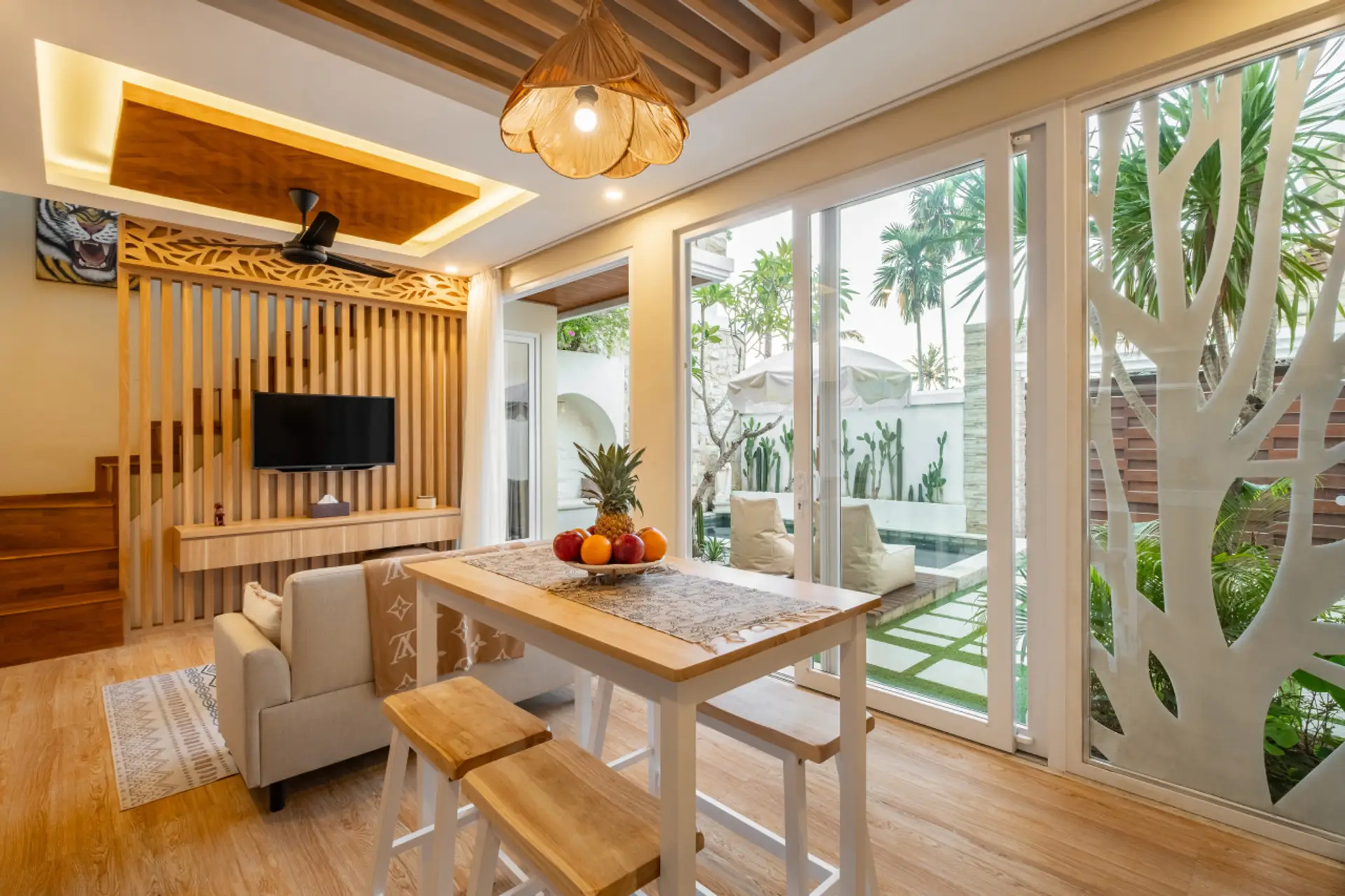 Living area complete with a Smart TV and outdoor views of the pool.