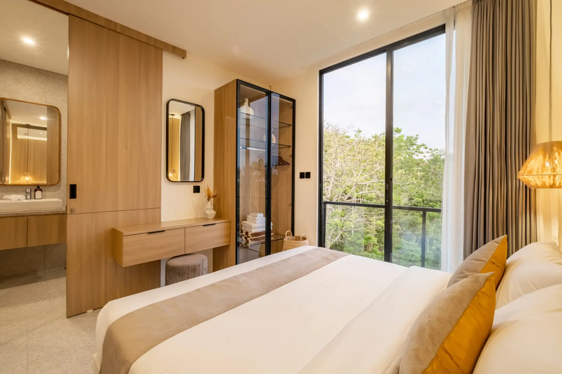 Bright and cozy bedroom with a panoramic green view and natural wood accents.