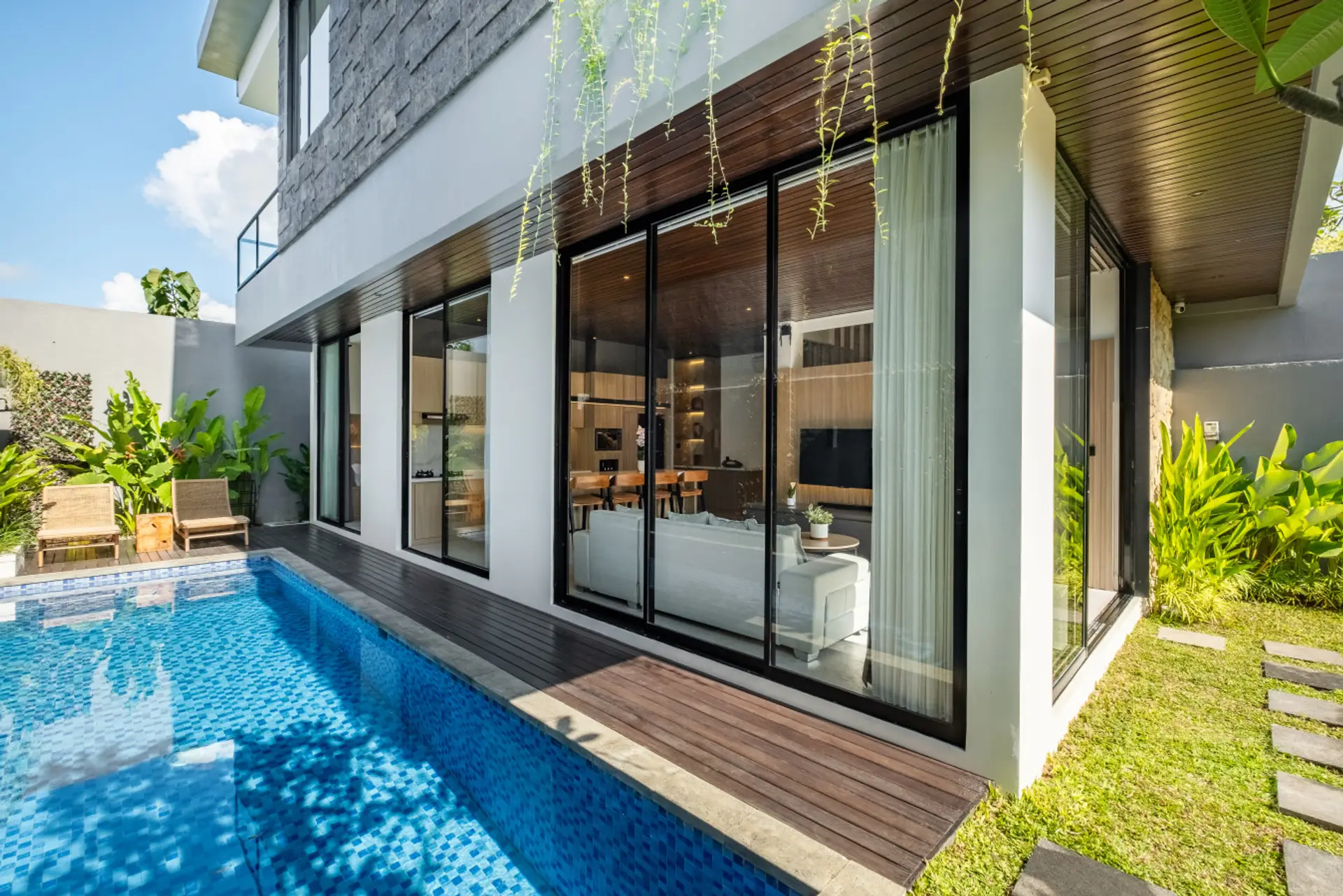 Private villa with a stylish pool and lush garden view.