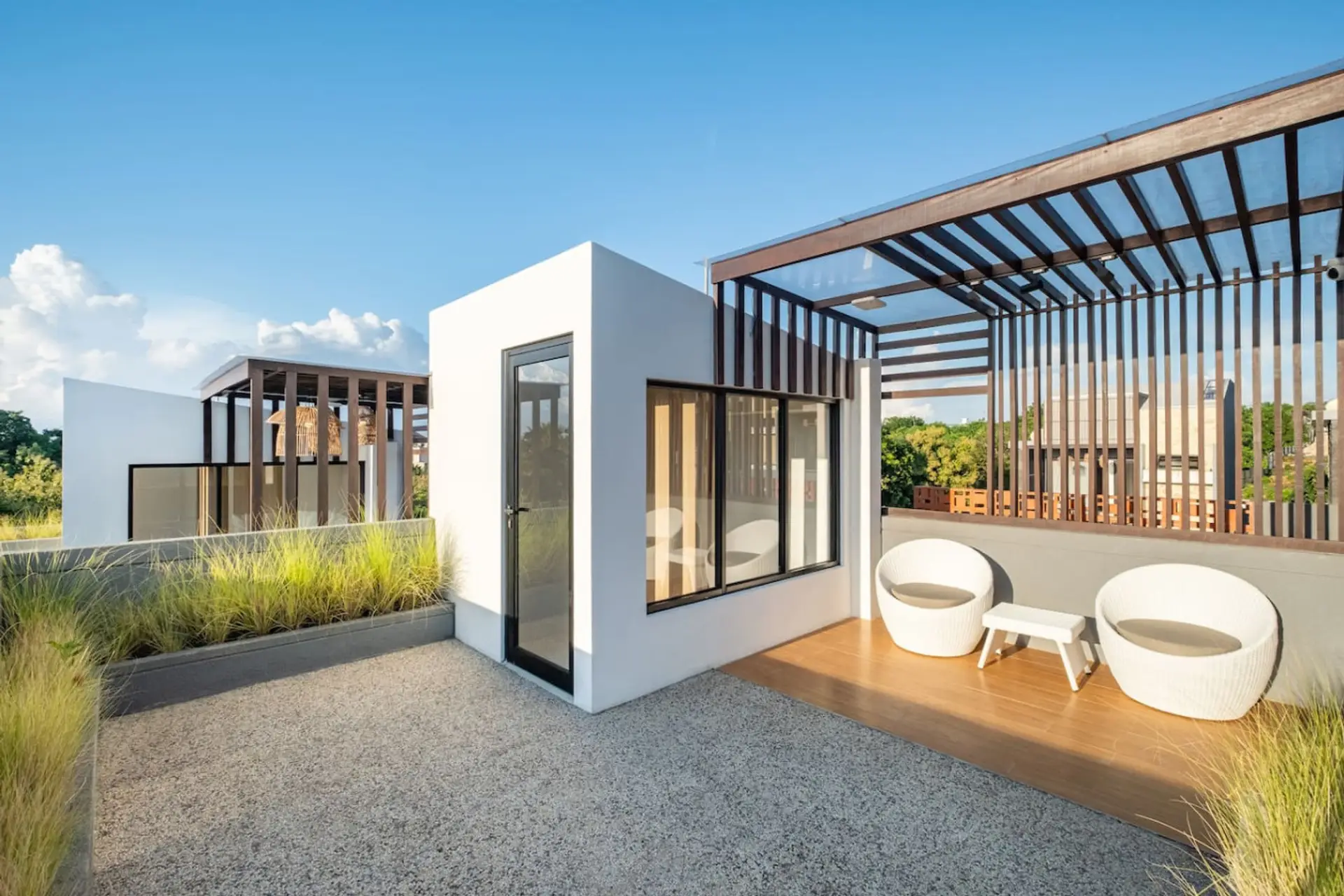 Private rooftop lounge with lush turf and cozy seating—perfect for relaxing under the sky.
