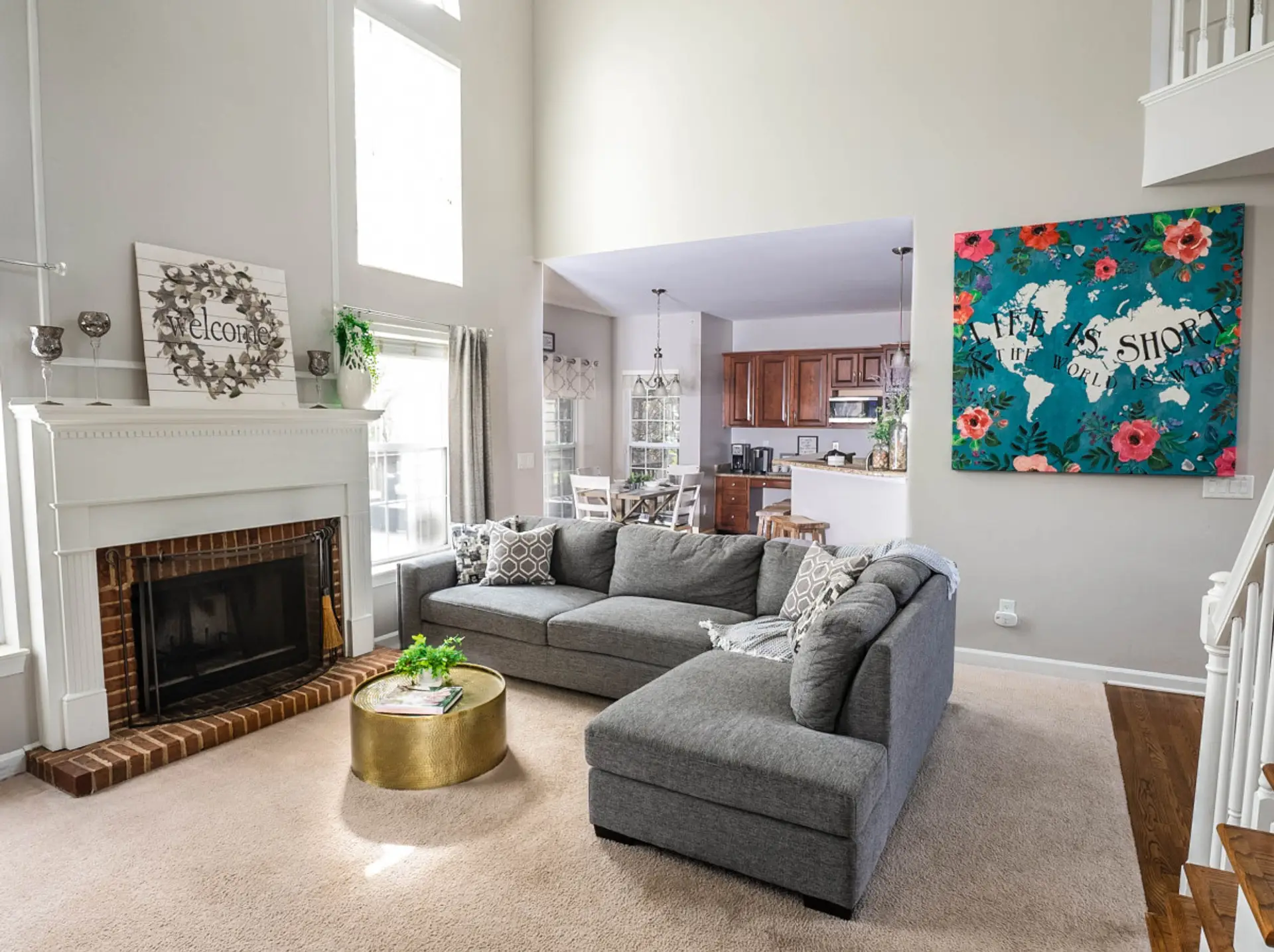 There's plenty of breathing room in this 2 story living room with ceiling fan.