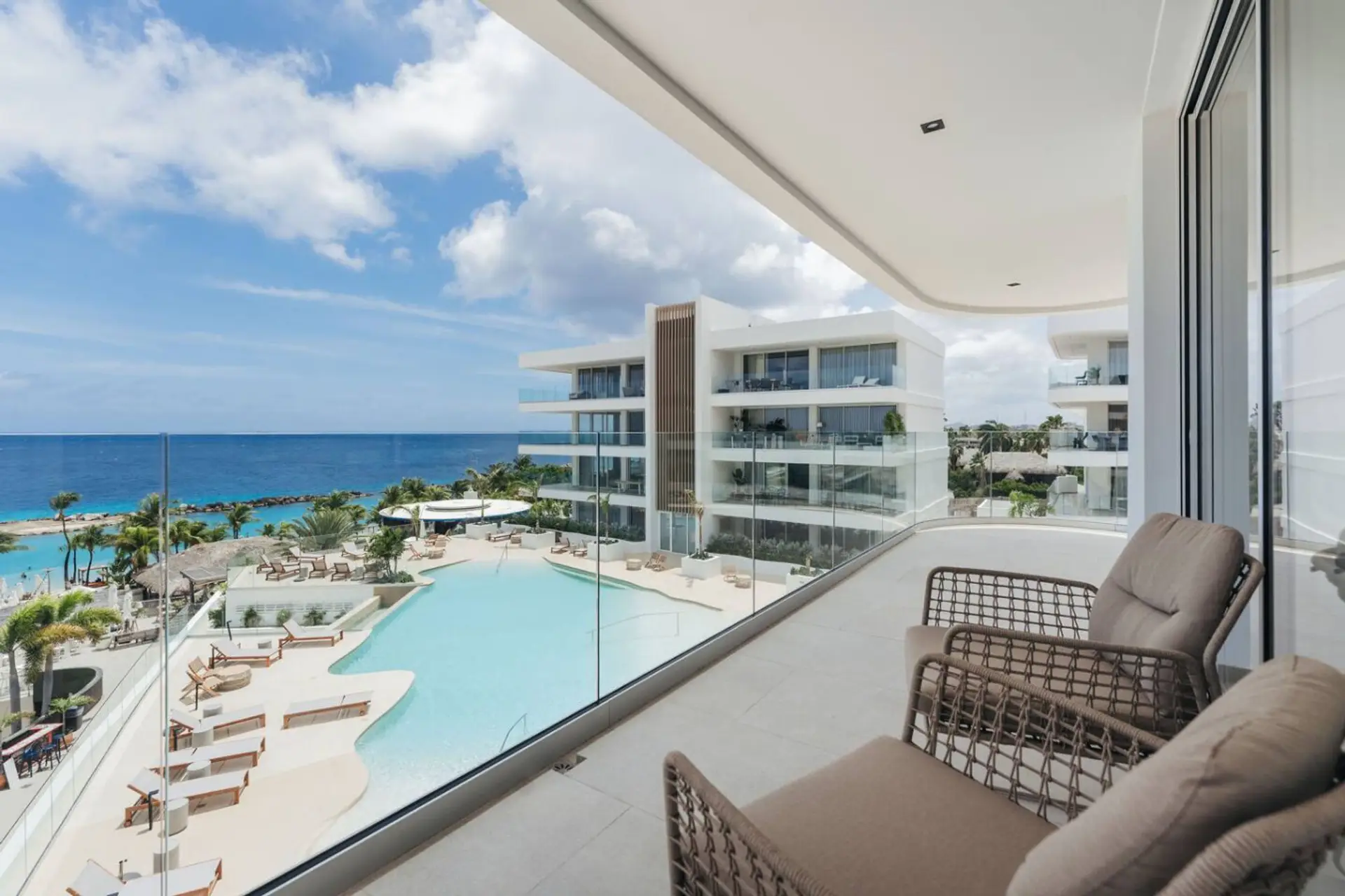 Breathe in that ocean breeze! This stunning balcony view overlooks the sparkling pool and endless sea.