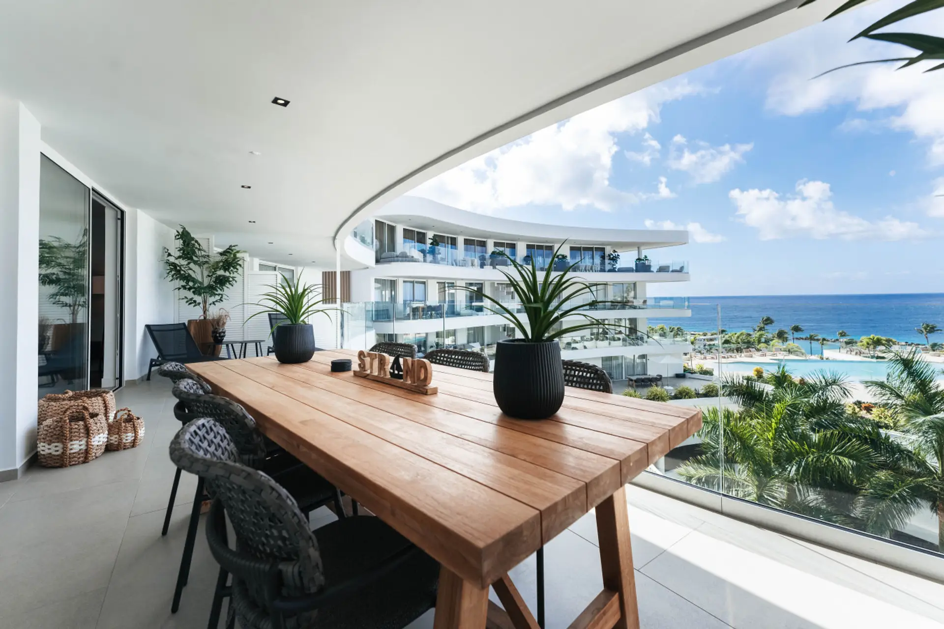 Spacious balcony with comfortable seating and beautiful views of the pool and ocean—an ideal spot to relax, enjoy the breeze, and take in the scenery at One Mambo 31.