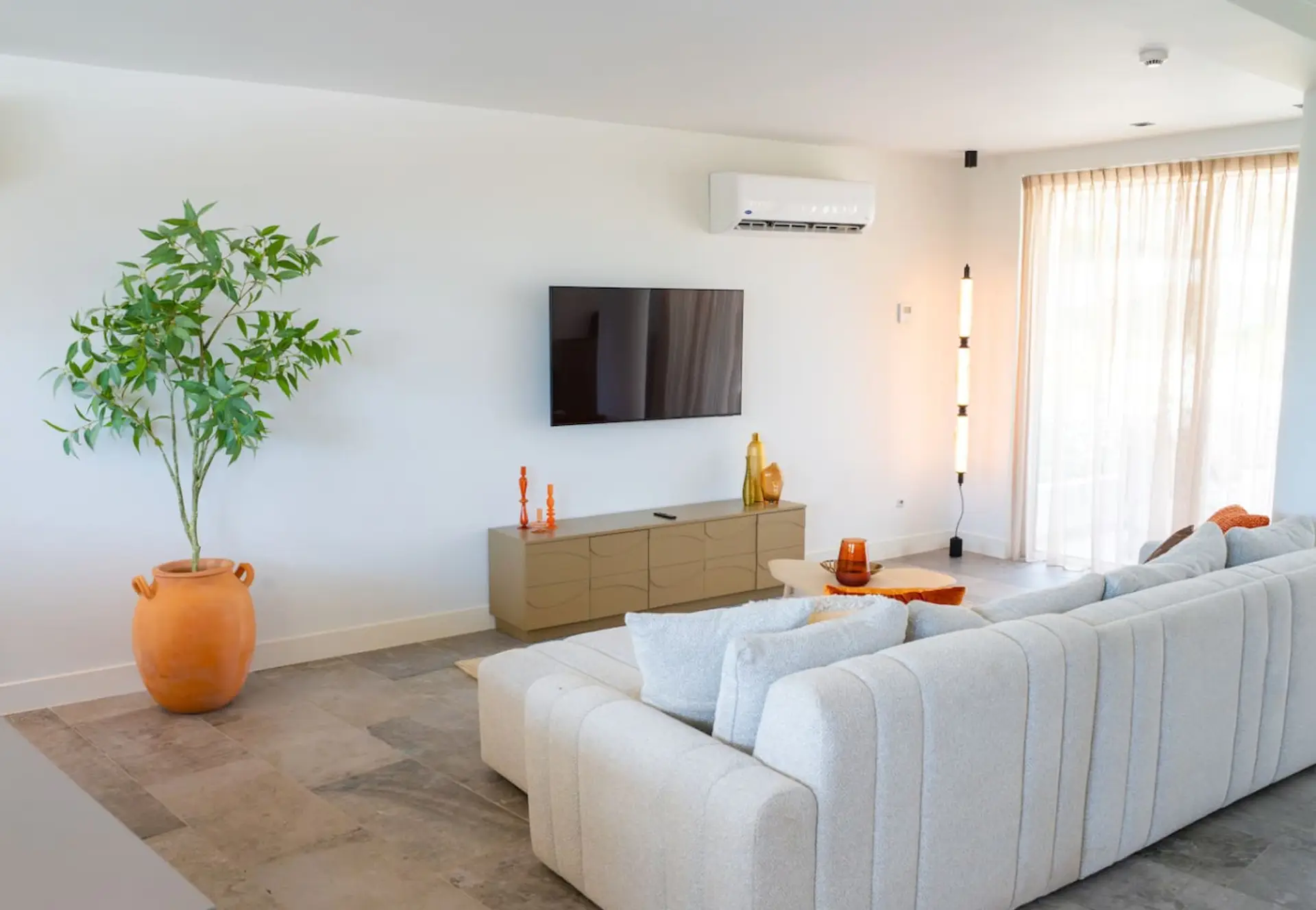 Bright and comfy living area with a cozy sofa and TV—perfect for winding down after a day out.