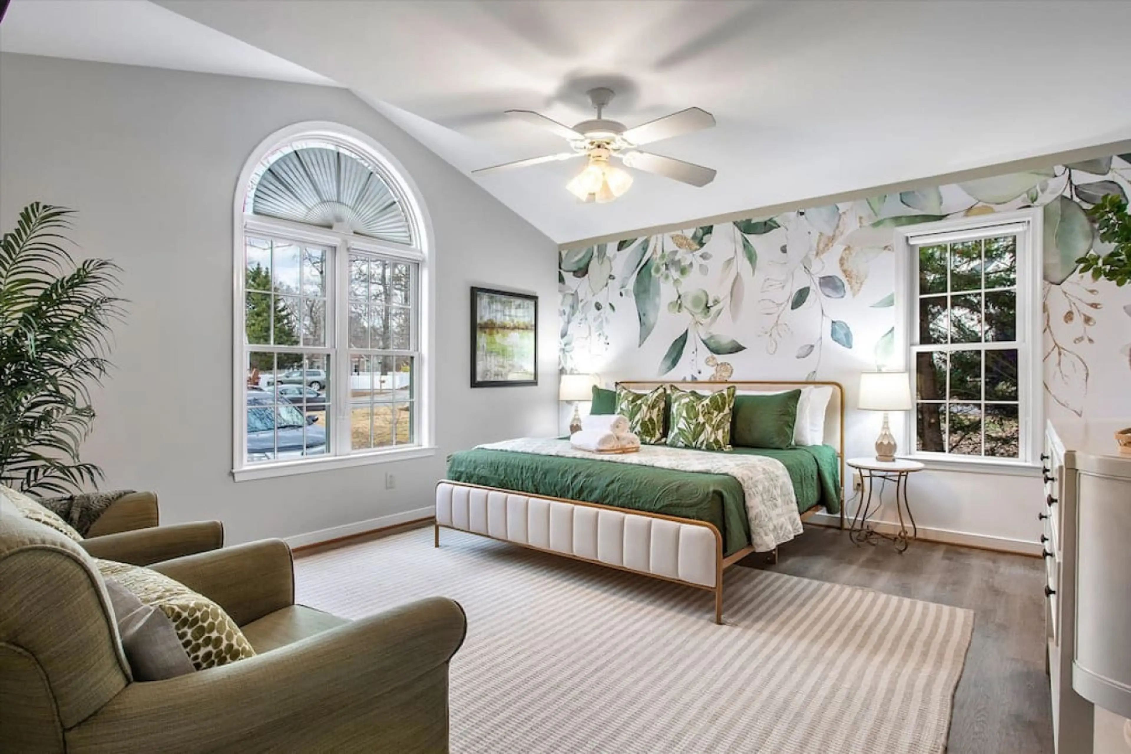 Elegant & refreshing! Draped in calming greens, this spacious retreat features a king bed, ceiling fan, natural lighting, Roku TV, dresser, ensuite bath, and extra seating.