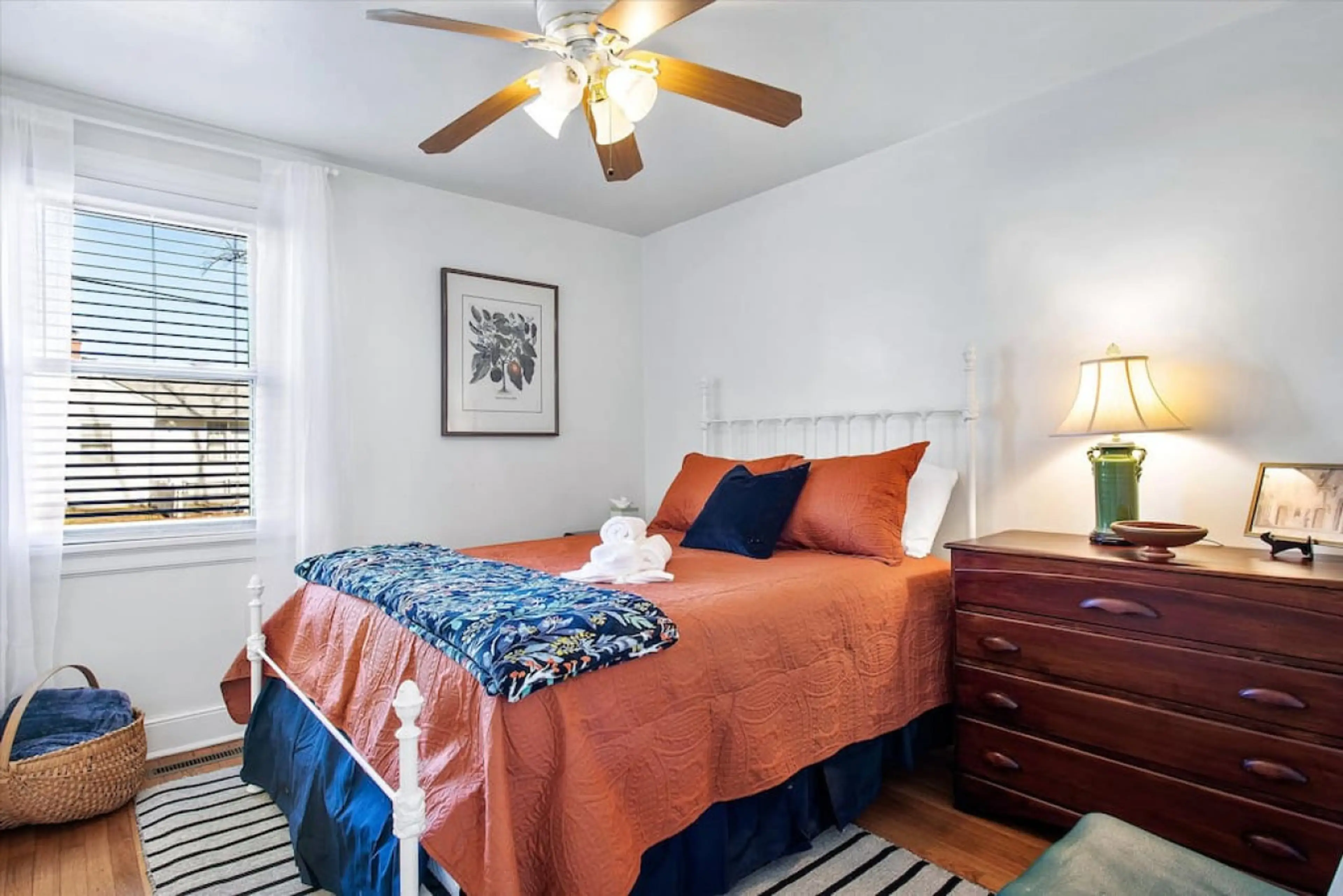 Cozy and inviting! Another queen bedroom with soft décor, a Jack and Jill bathroom, and a ceiling fan for comfort.