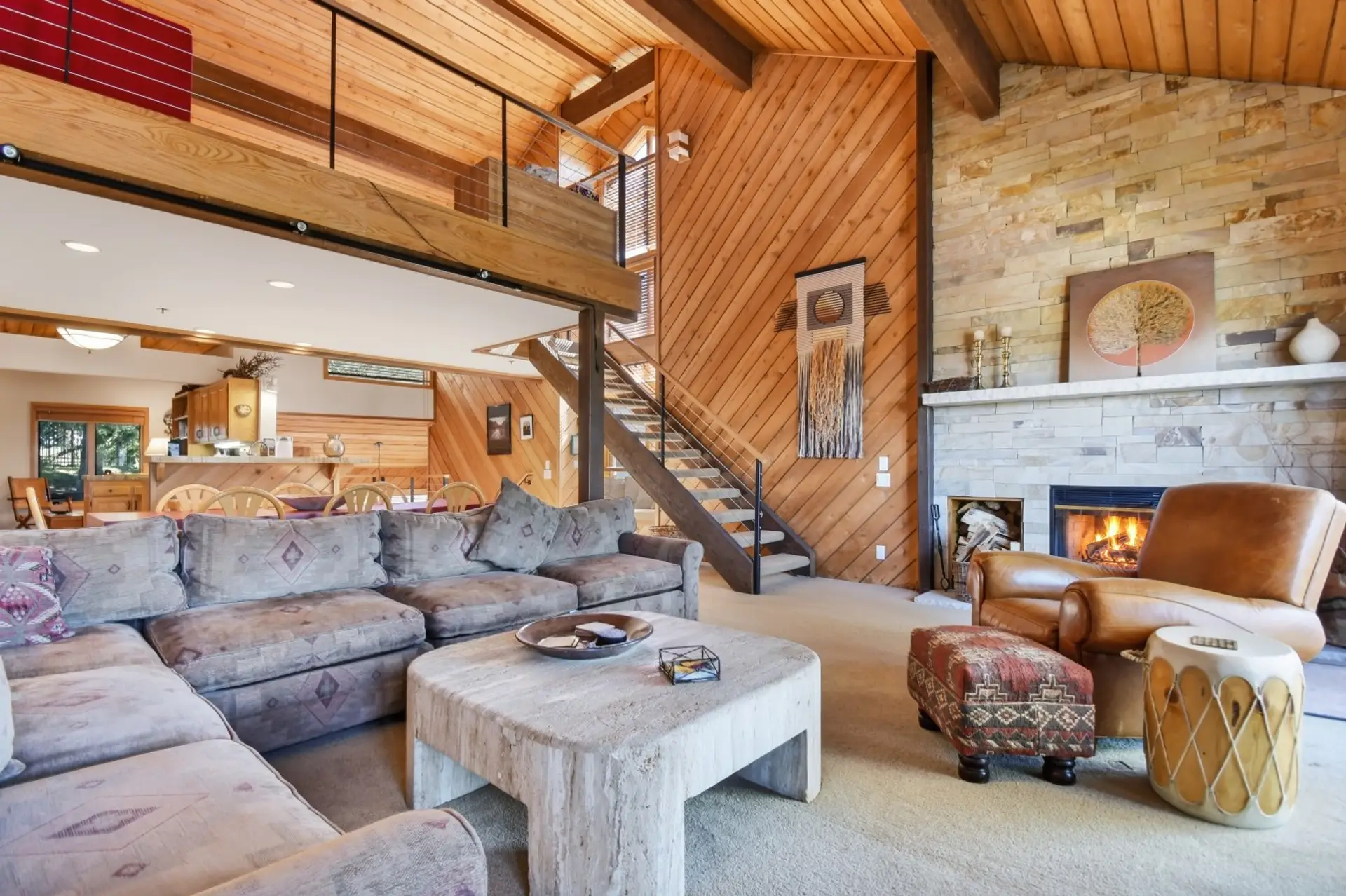 Living Room with Vaulted Wood Ceilings, a Cozy Sofa, TV and Wood Burning Fireplace