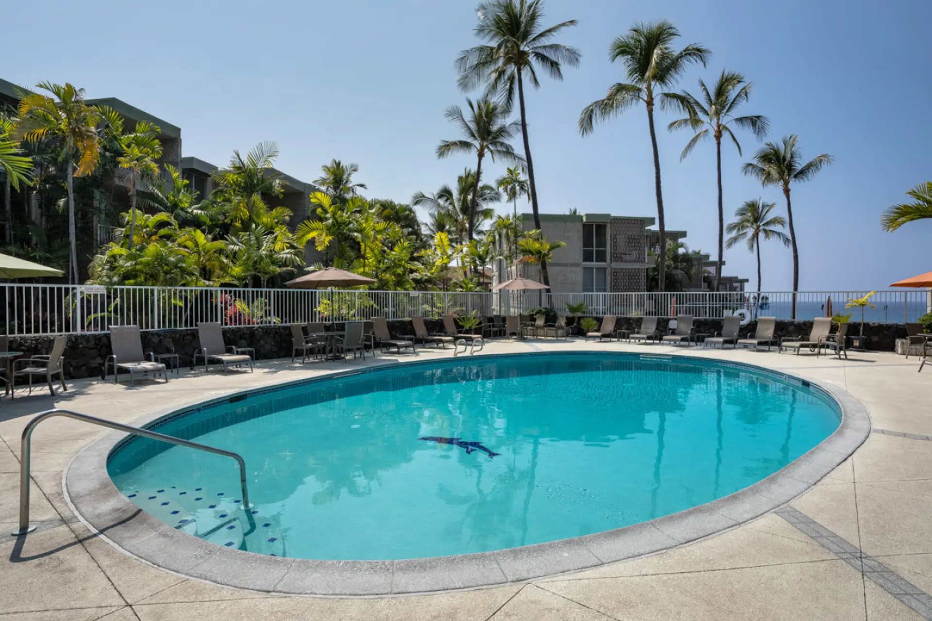 The beautiful complex pool with lots of lounge chairs for soaking up the sun