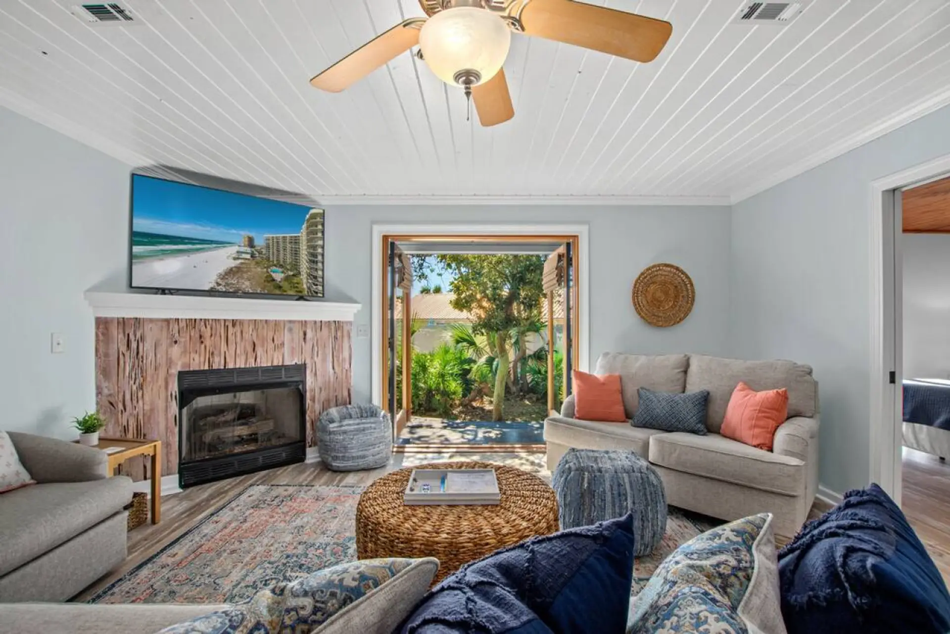 Relax in this charming coastal living area with French doors, a smart TV, and a pull-out sofa—perfect for 2 guests seeking comfort and style.
