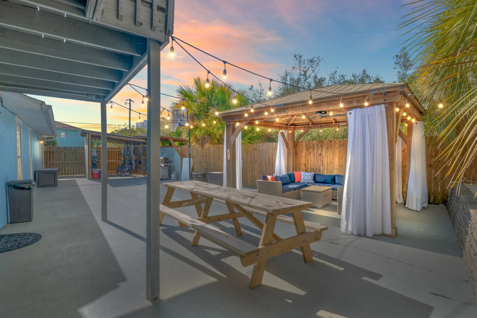 Relax poolside in the covered seating area surrounded by Edison lights and romantic curtains!
