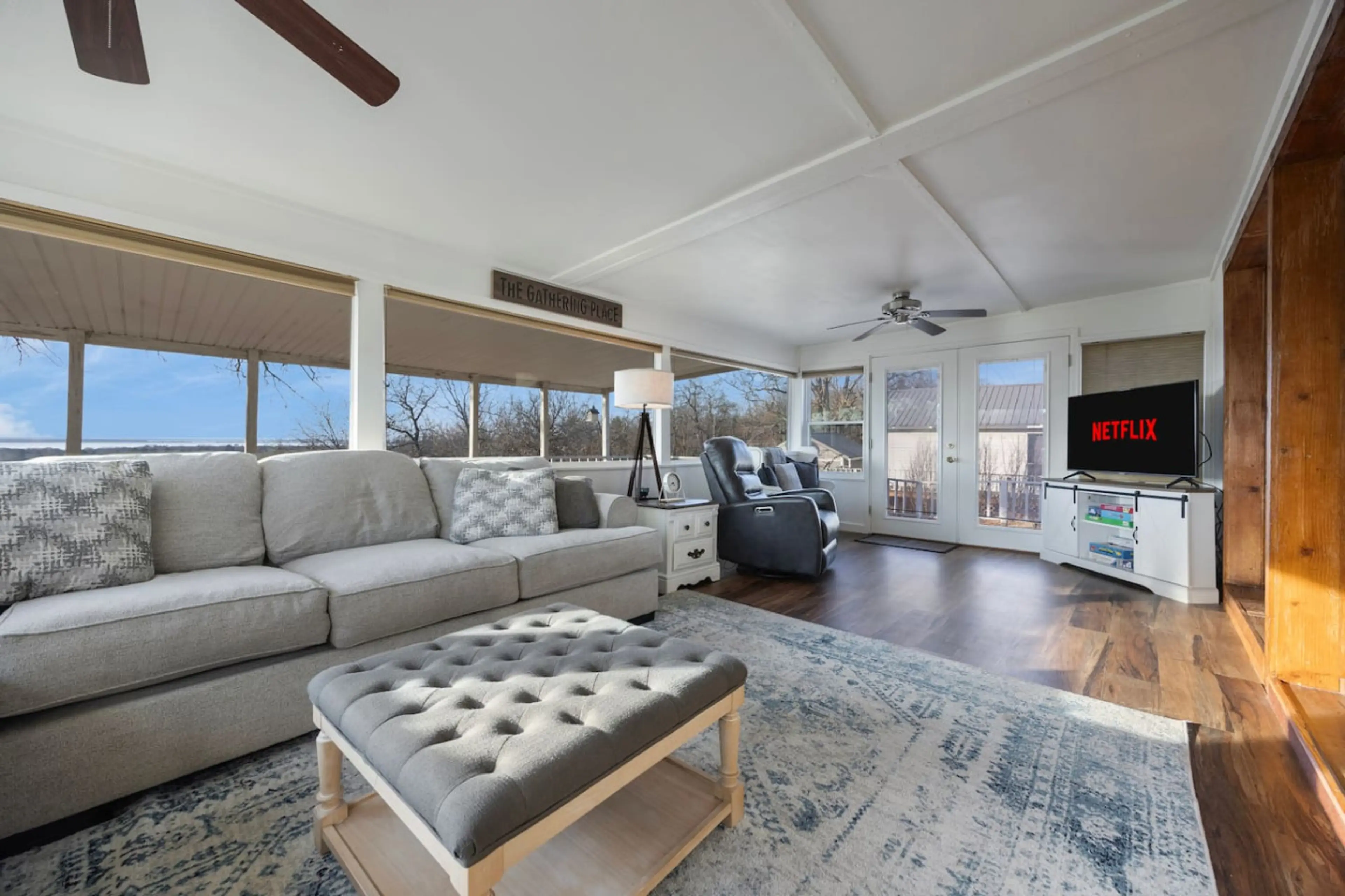 Living area with lake views, ample seating, and smart TV