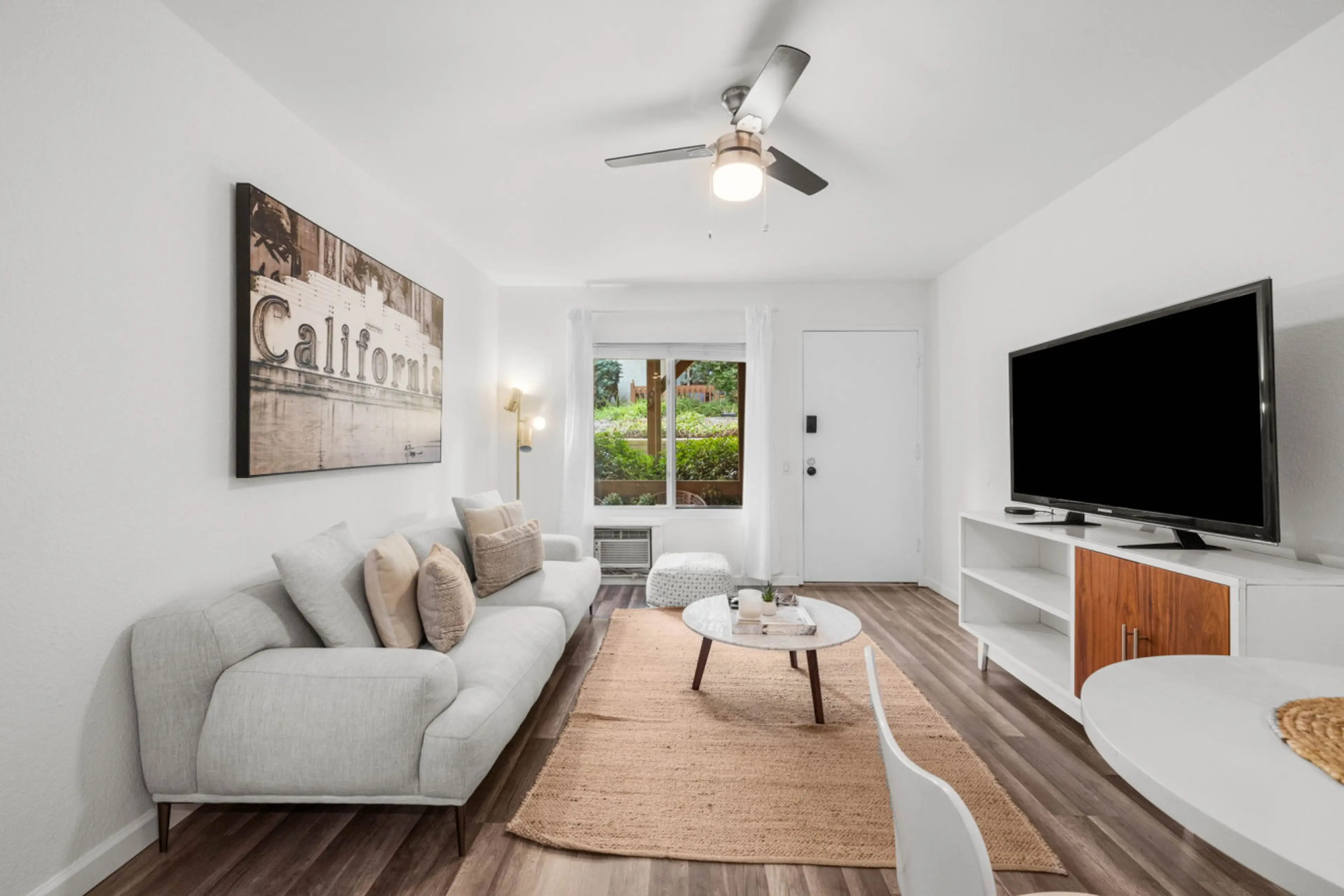 Relax in the stylish living room featuring a comfy sofa, flat-screen TV, and warm California charm.