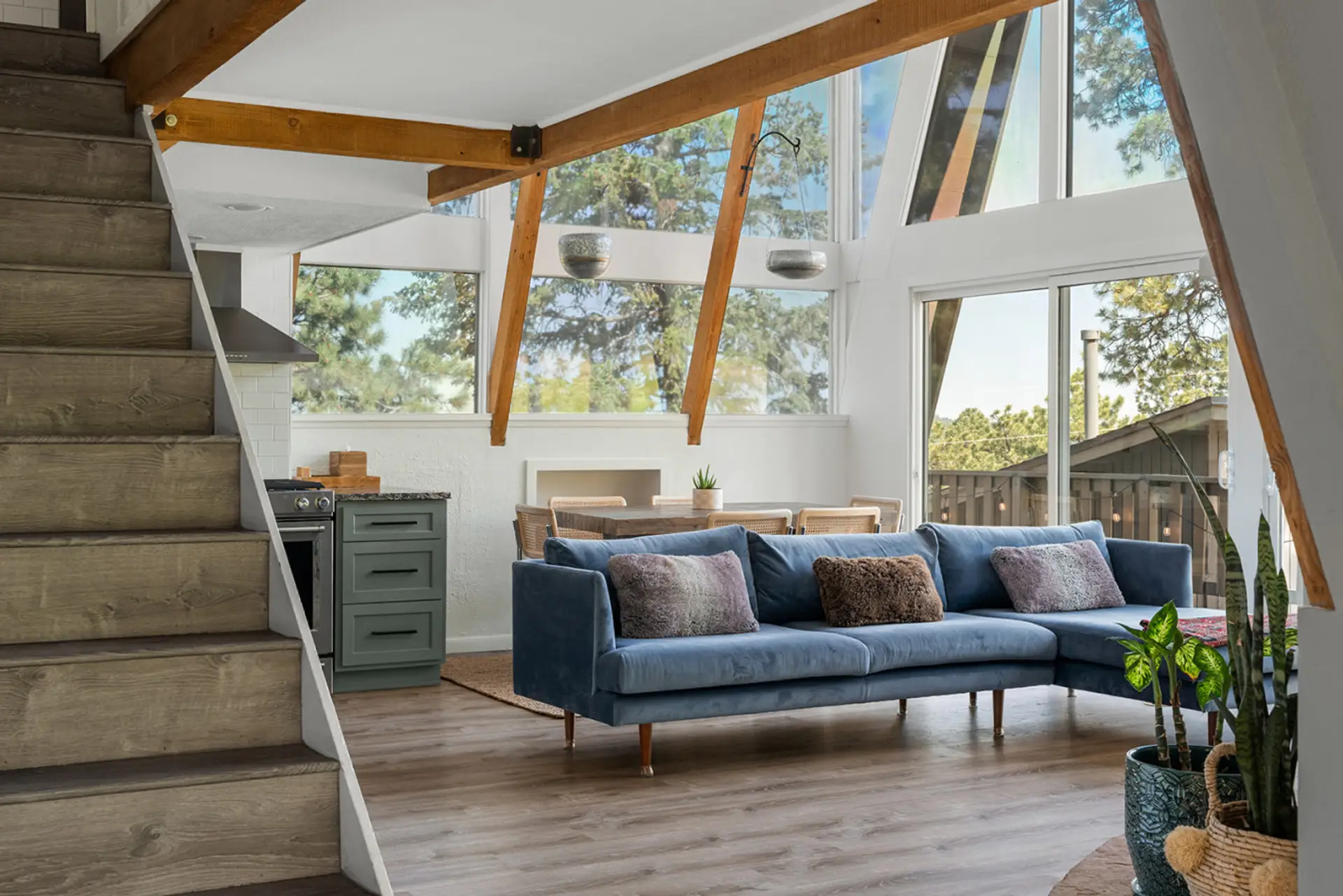 Spacious living area with vaulted ceilings and floor to ceiling windows with views