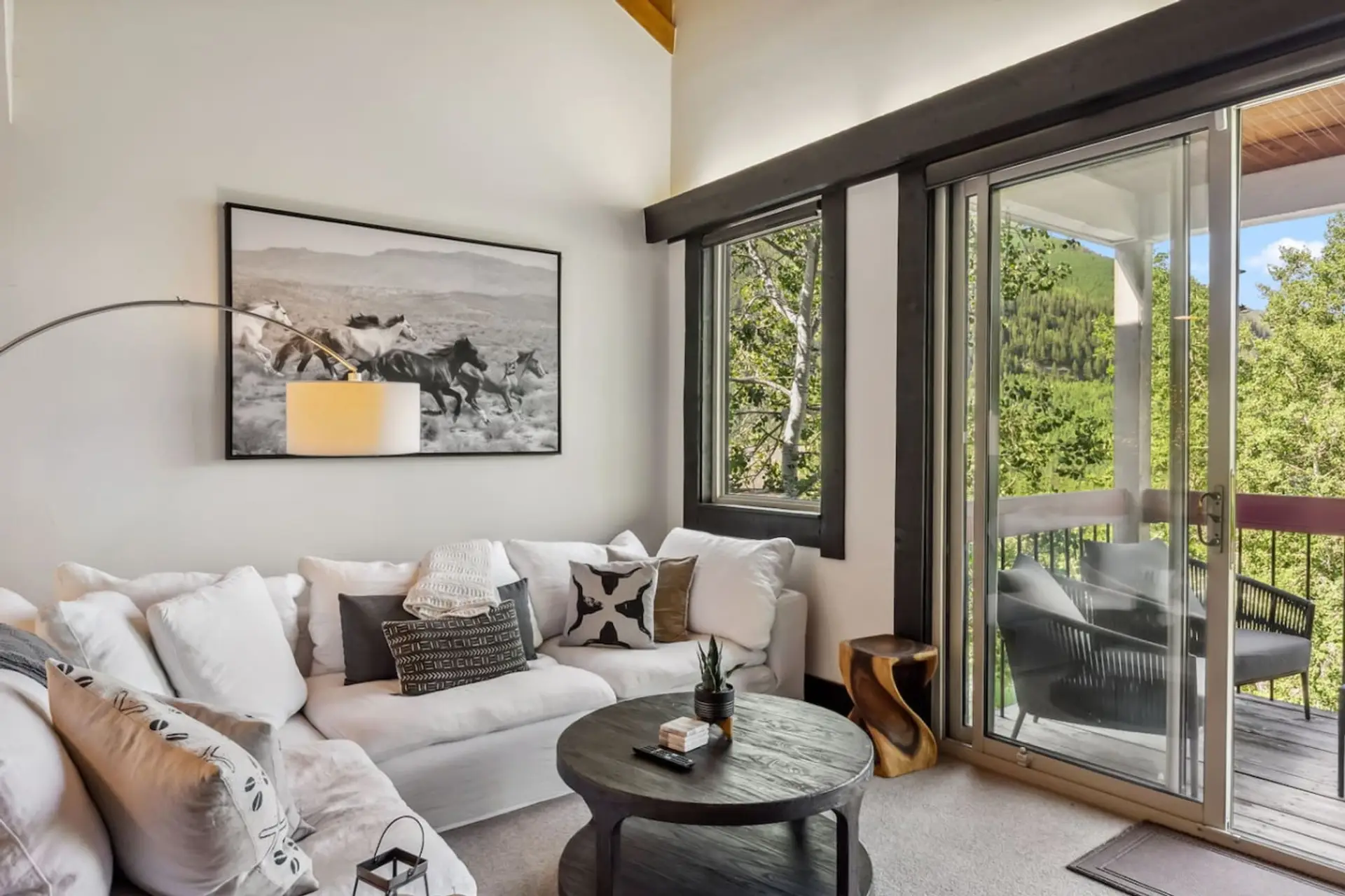 Elegant living room with beautiful views, fireplace, and large smart TV