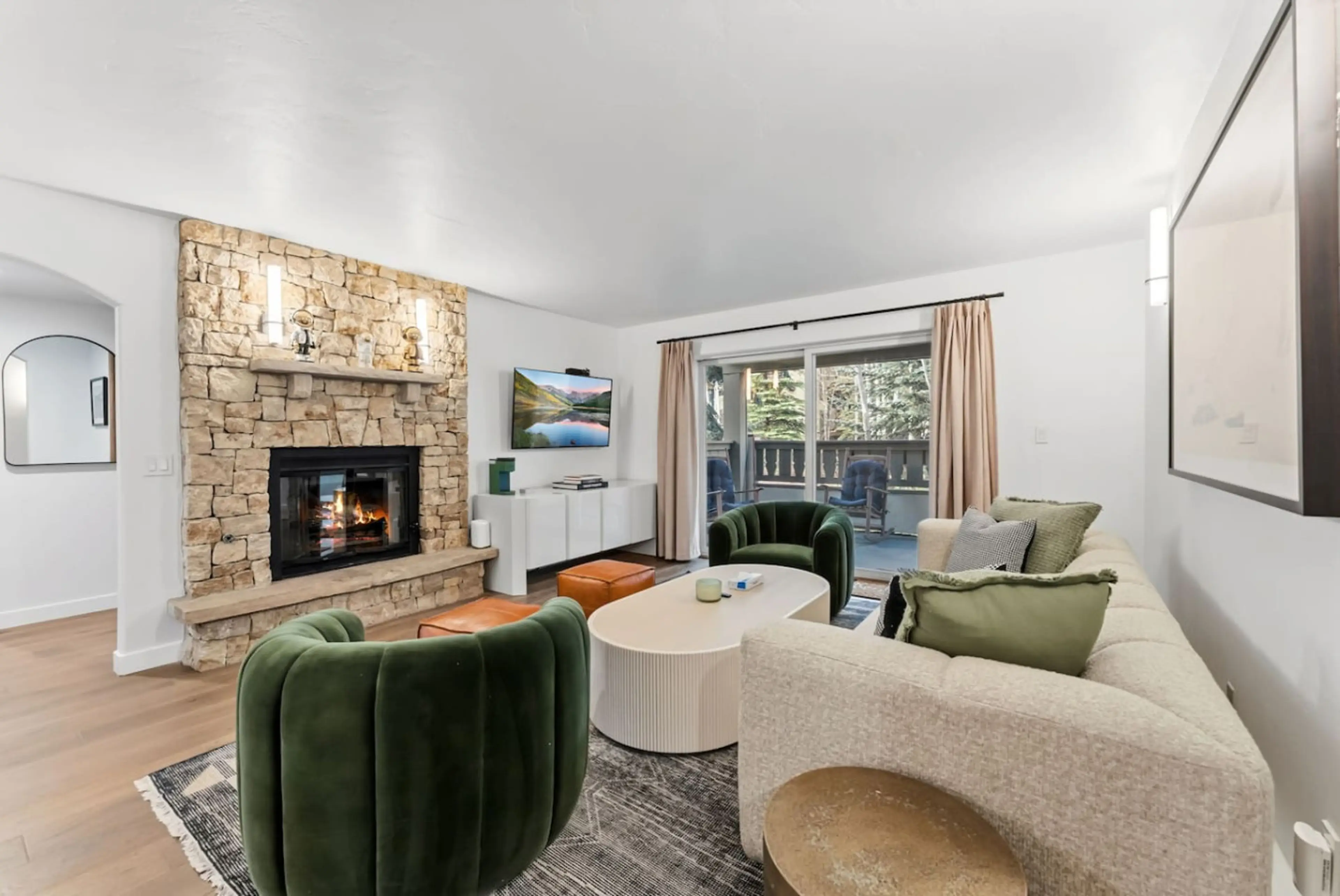 Newly renovated living room with fireplace, smart TV, and walkout balcony w/views