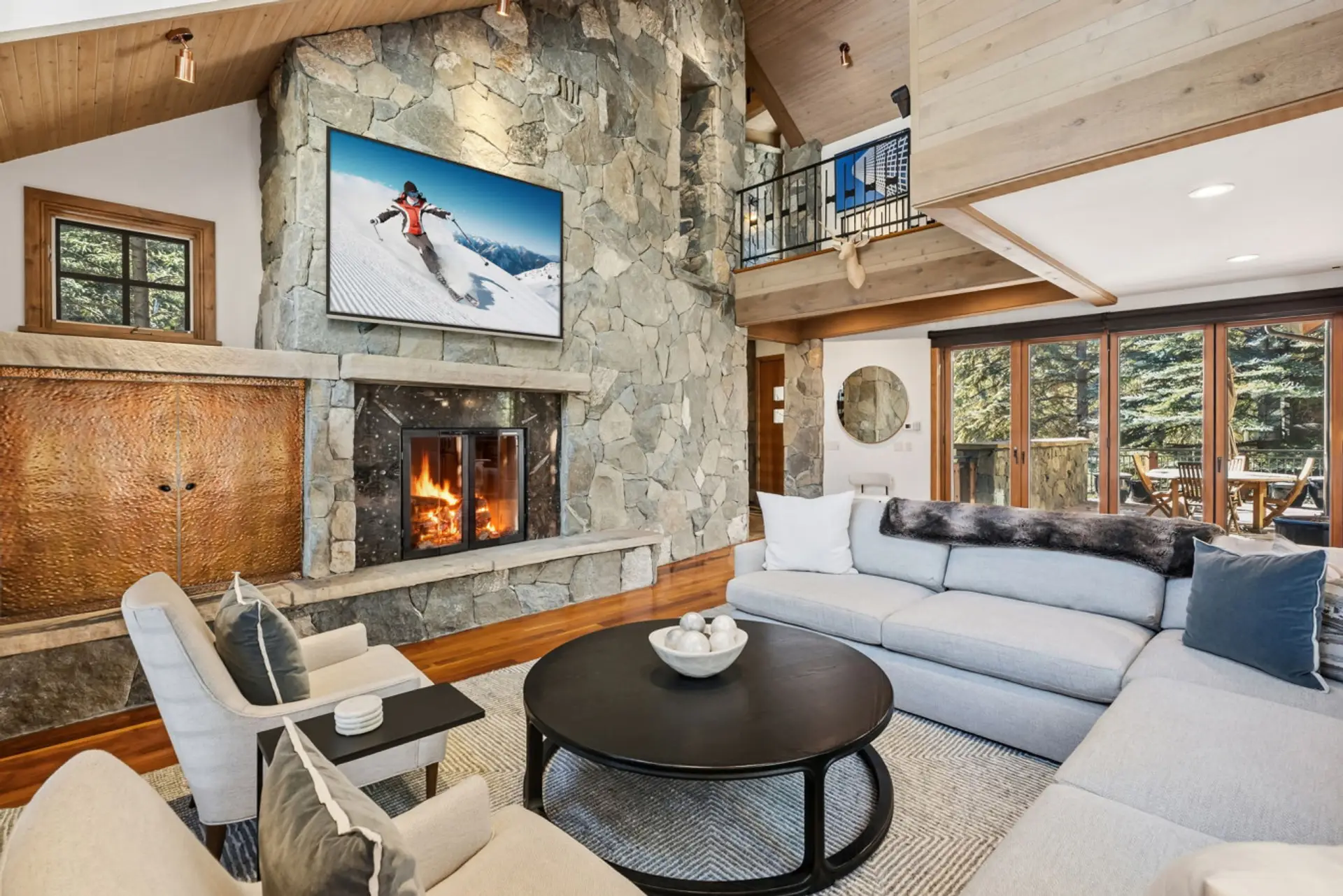 Living room with plenty of seating, gas fireplace and large smart TV