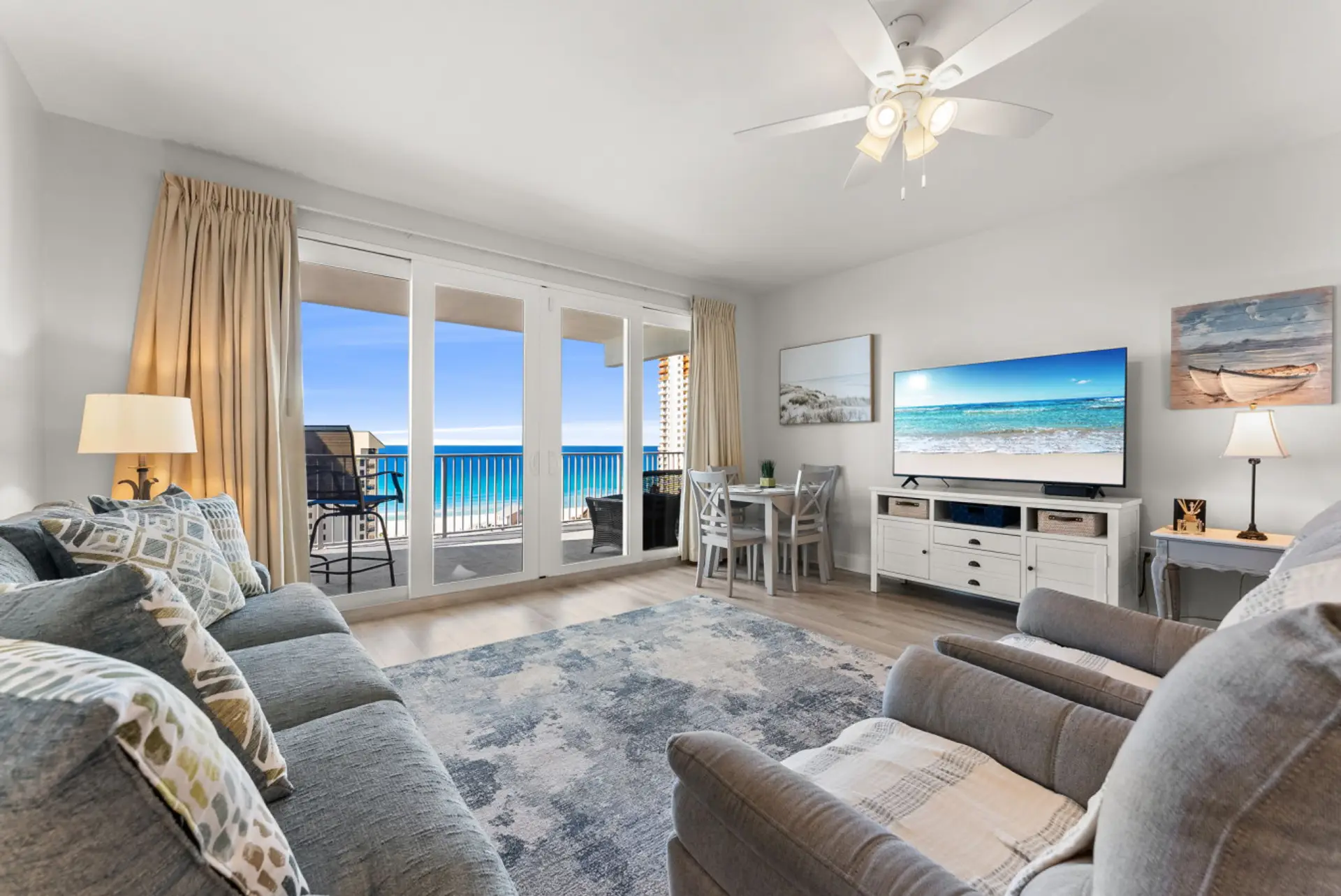 Relax in the cozy living area with a large smart TV and floor-to-ceiling windows showcasing stunning ocean views.