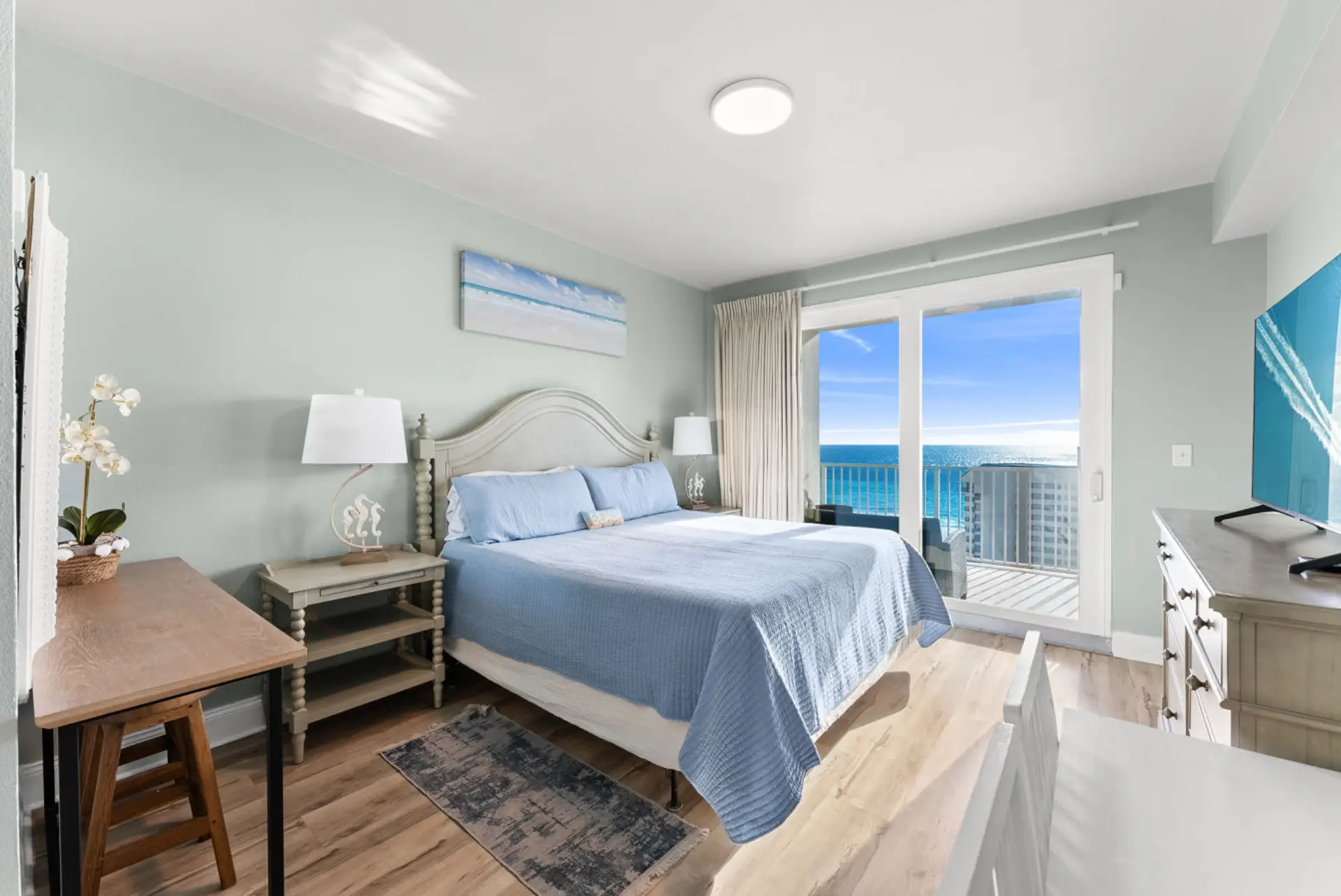 Serene master bedroom with a plush king bed and private balcony access showcasing breathtaking Gulf