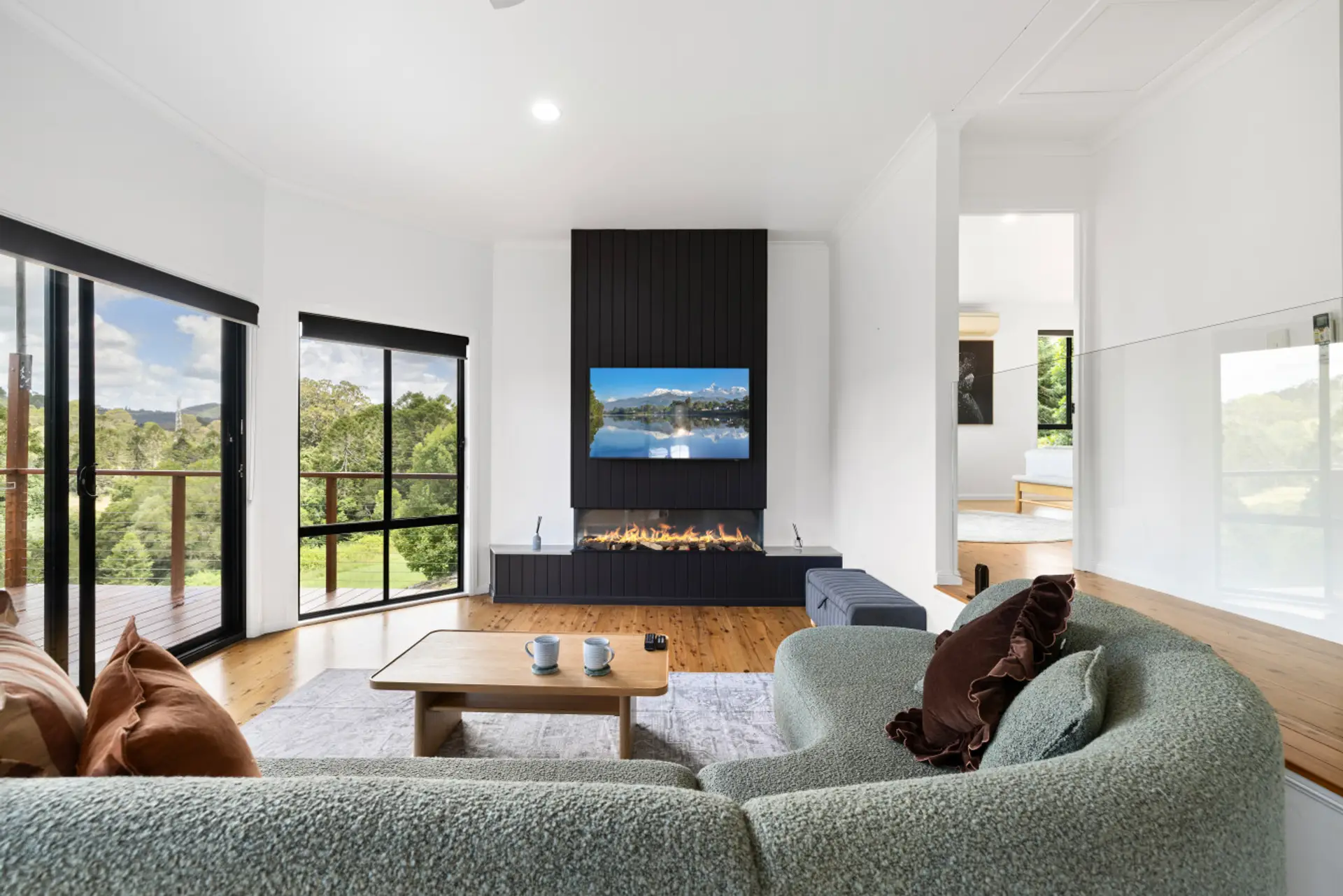 Living room with electric fireplace, Smart TV and balcony access
