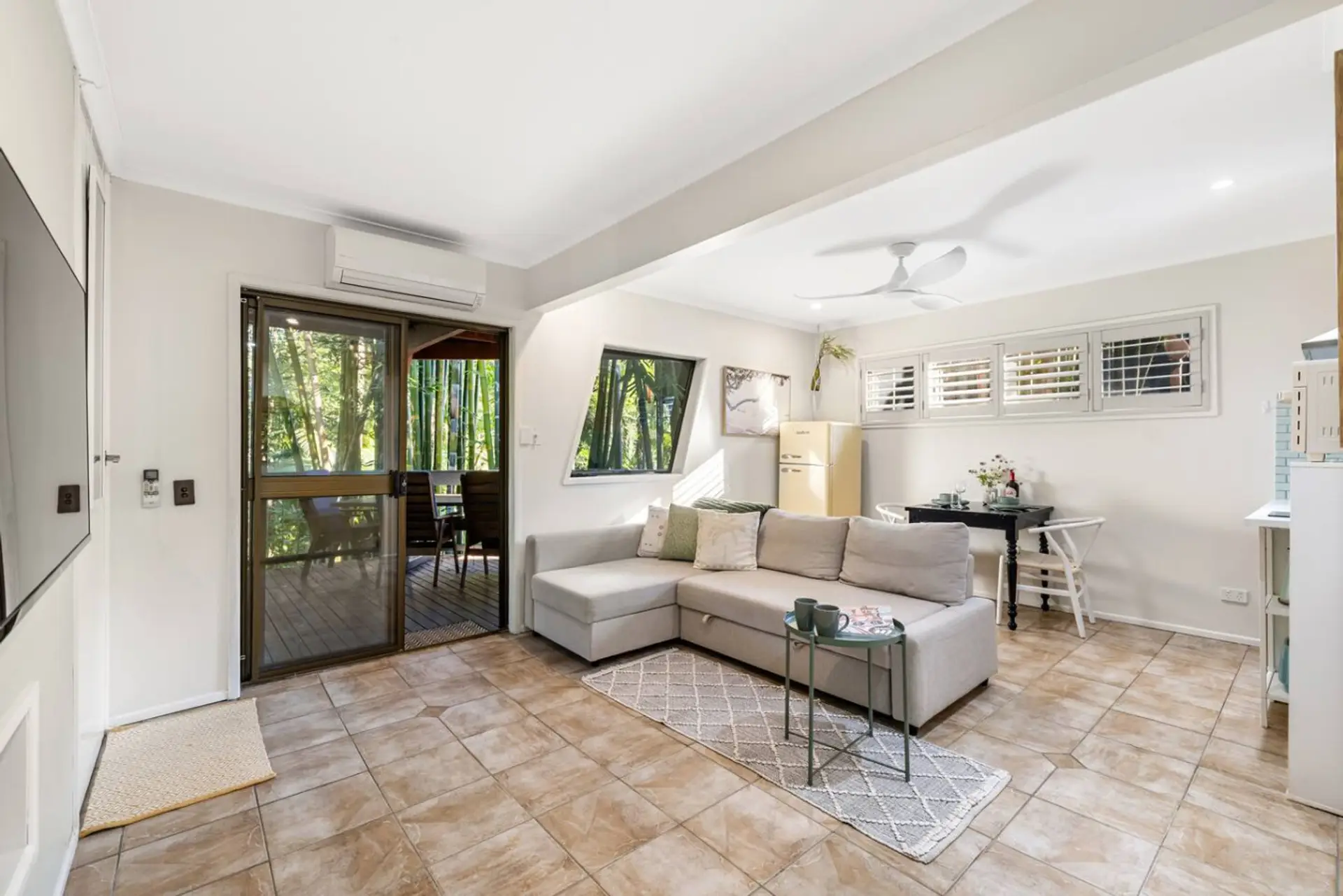 Open plan living, dining and kitchenette with balcony access