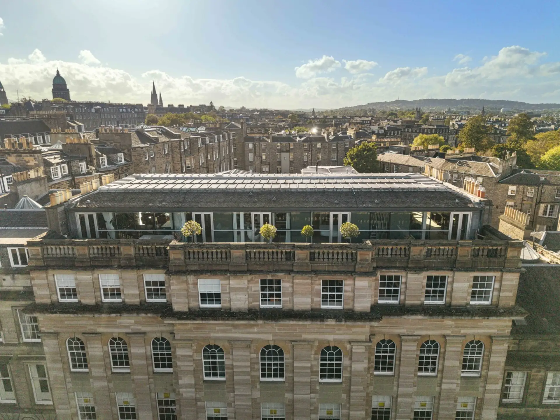 Rooftop terrace on a historic stone building overlooking the Edinburgh skyline