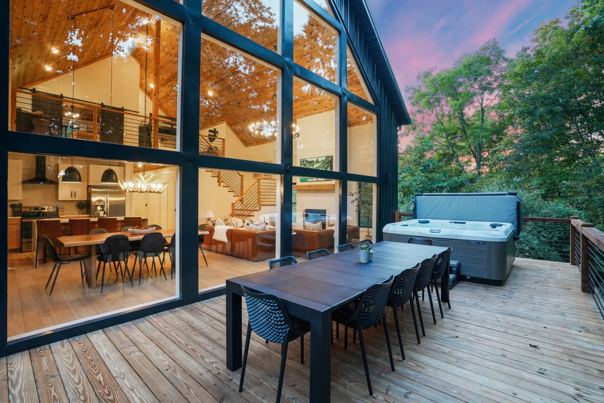 The oversized back deck which spans the entire width of the cabin is gorgeous! Here you'll find a 6-person hot tub, 10-seat dining table, Kenmore grill, and beautiful forest views.