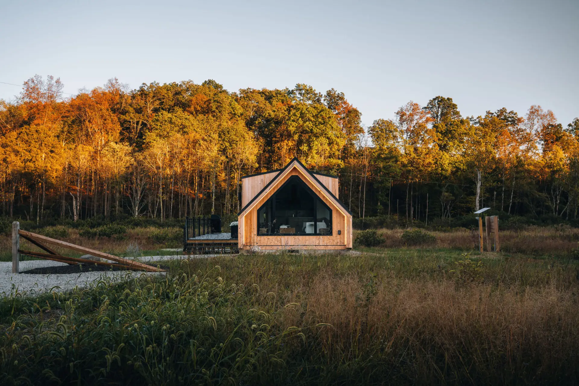 The Timber Haus sits tucked in a prairie with a vast forest backdrop.