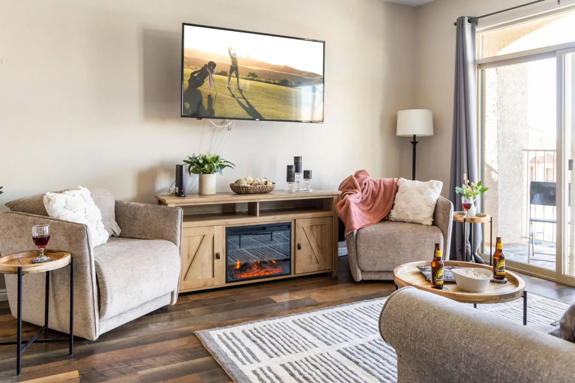 Extremely comfortable and stylish living room with fireplace, smart TV, and sleeper sofa.