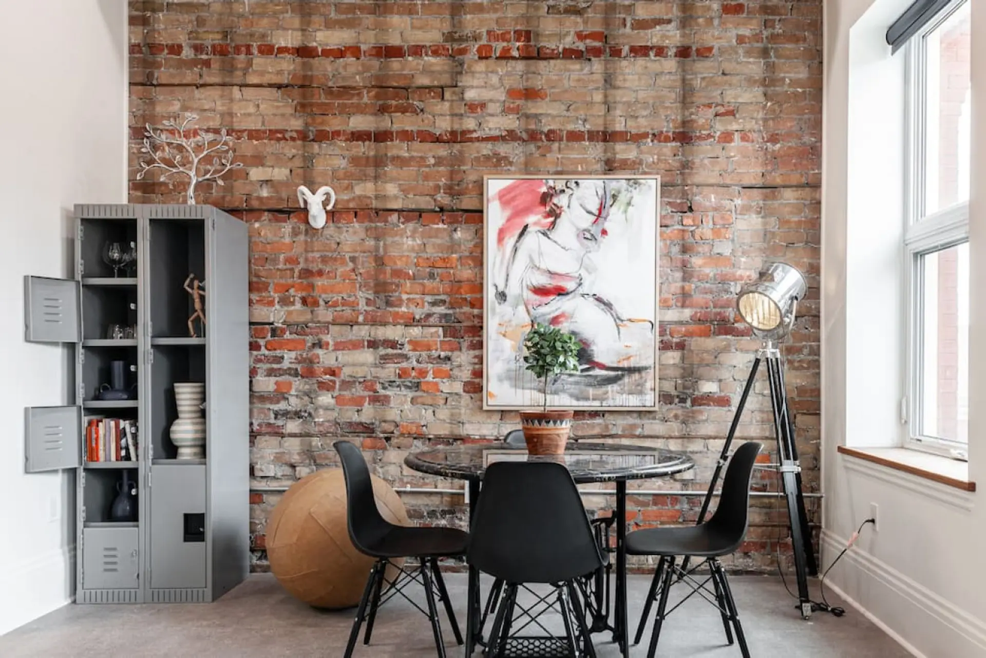 Discover urban elegance in our SoHo Loft's living area, bathed in natural light and enriched with art from around the globe. A stone's throw from Stratford's Avon Theatre and vibrant dining scene, it's an urban creative's dream