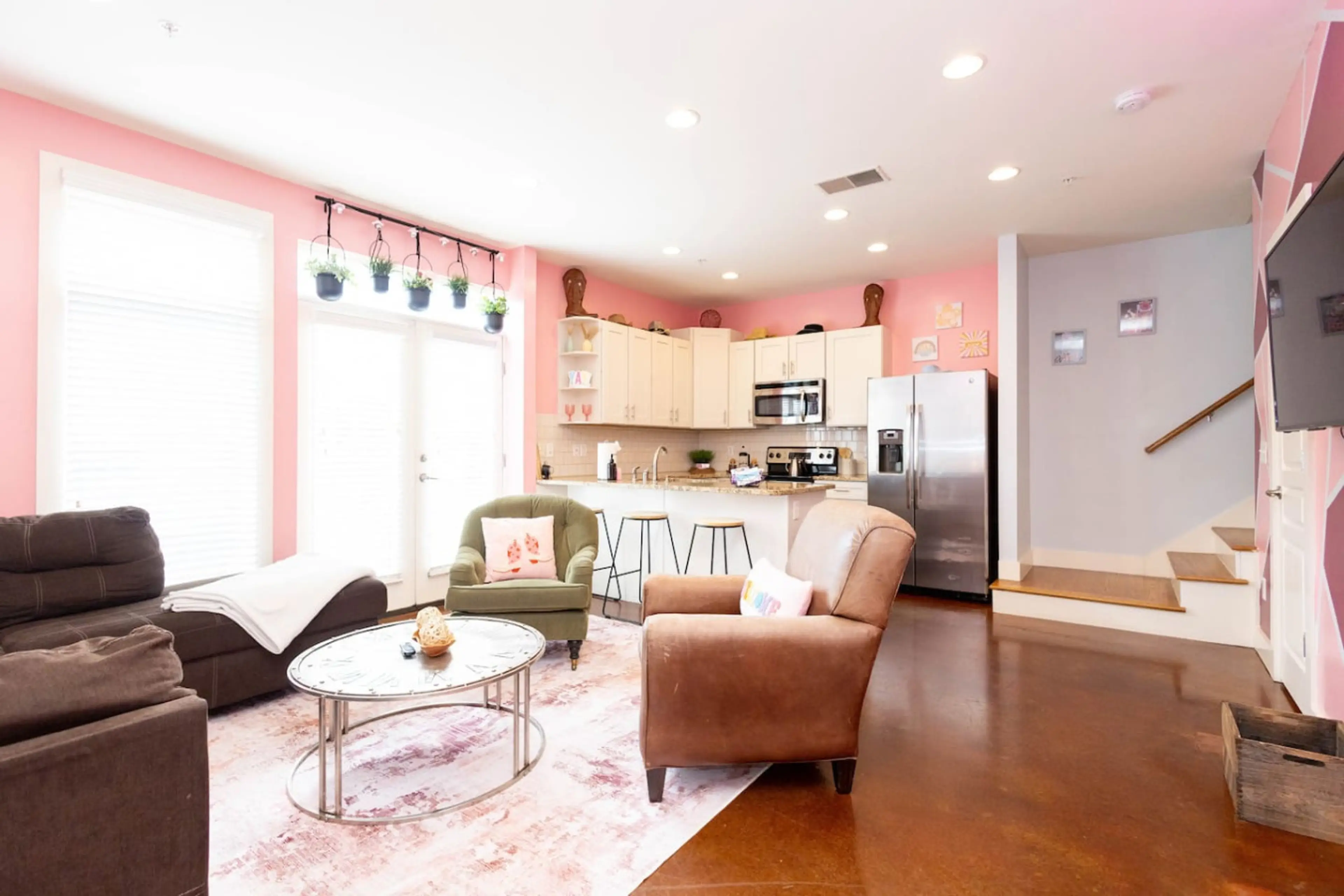 Bright, open, and oh-so-pink! This living space features a cozy sofa and chairs, a chic blush rug, and plenty of natural light. Perfect for sipping cocktails before hitting Broadway or lounging with the girls after a long day exploring Nashville.