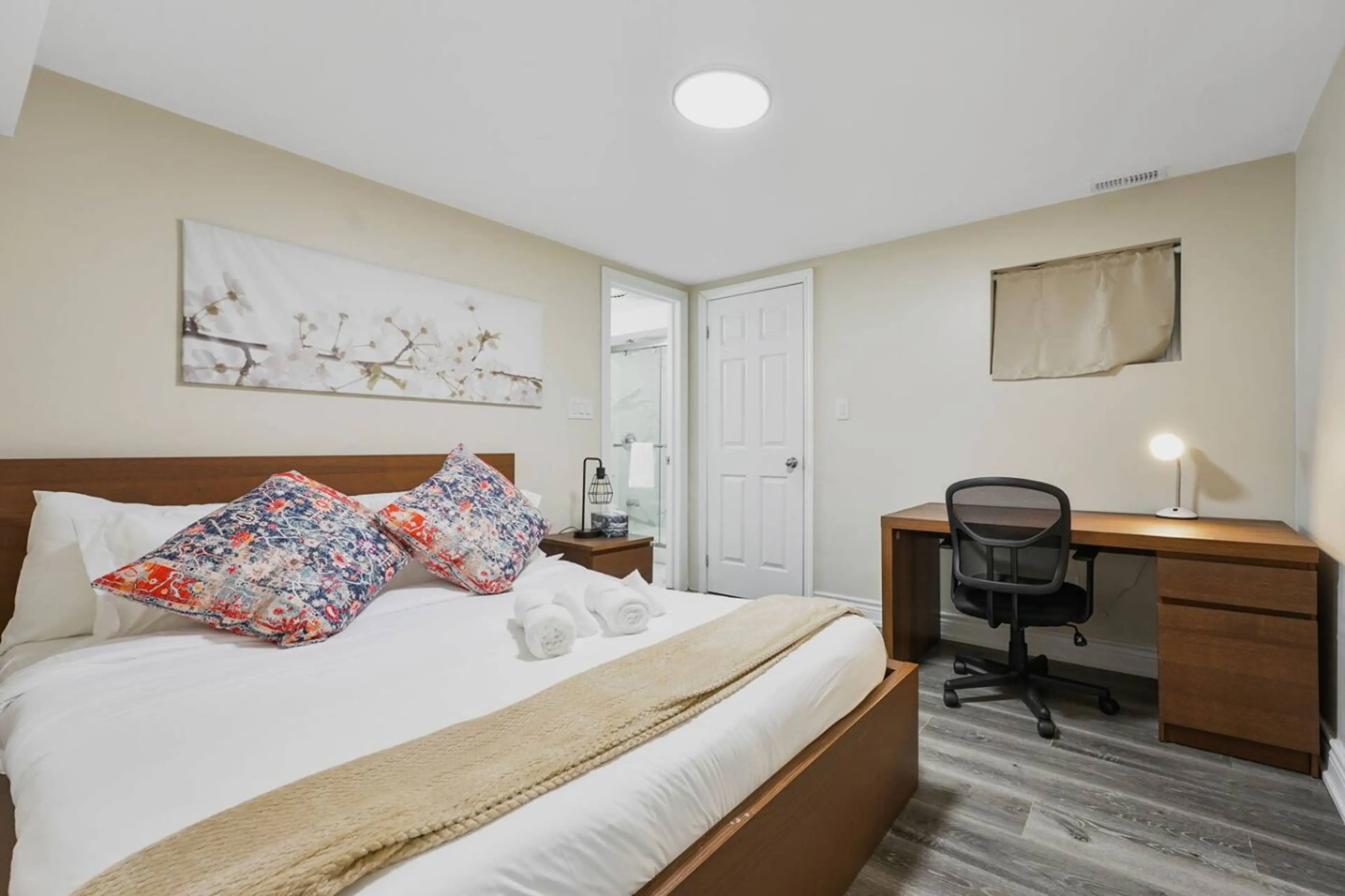 Experience the perfect blend of comfort and productivity in this inviting bedroom. A plush bed promises restful sleep, while a dedicated workspace allows you to stay connected. The private en-suite bathroom ensures ultimate convenience.