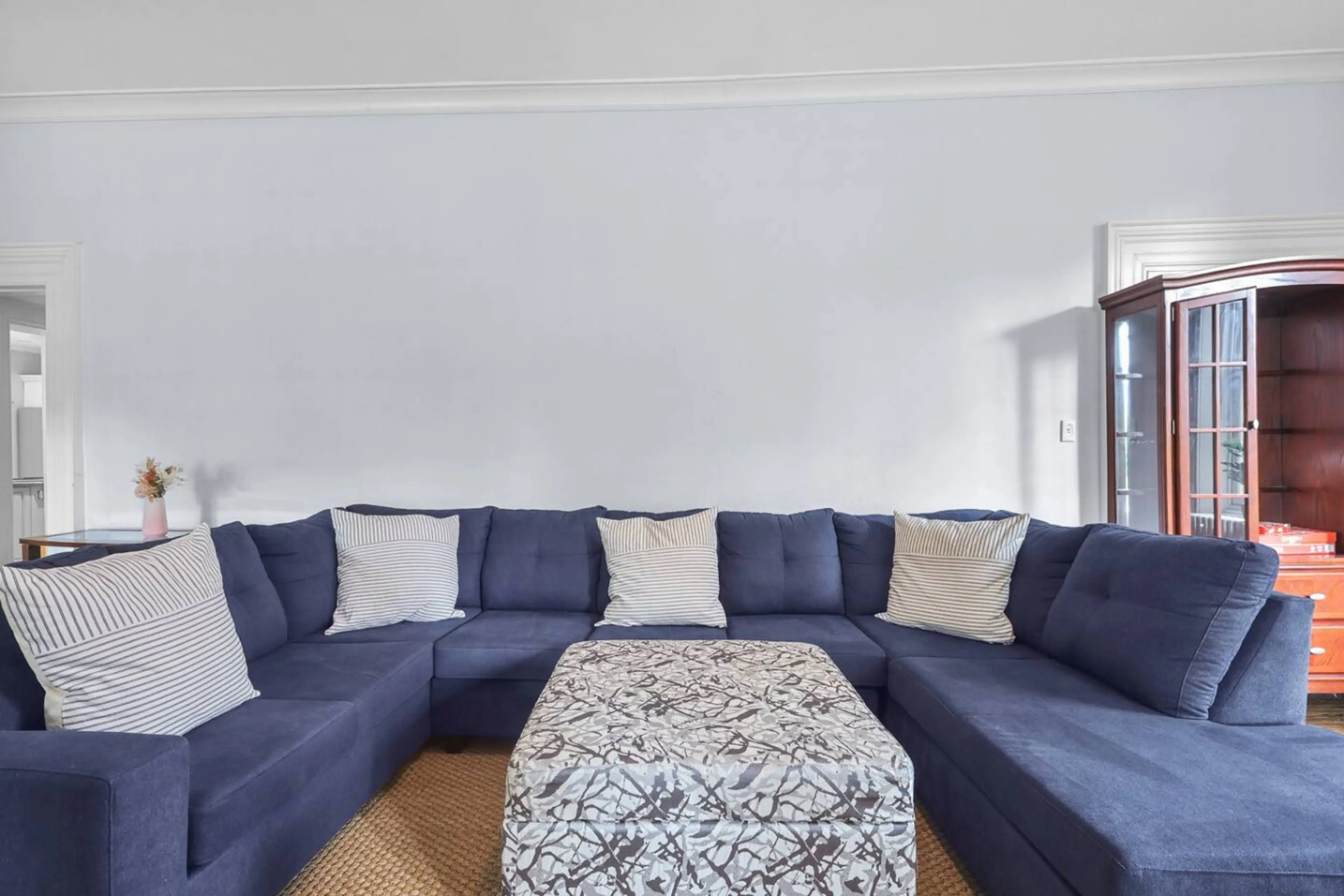 Settle into the plush comfort of our oversized sectional sofa. Perfect for movie nights, board games, or simply relaxing with a book. This inviting space is designed for ultimate comfort and connection.