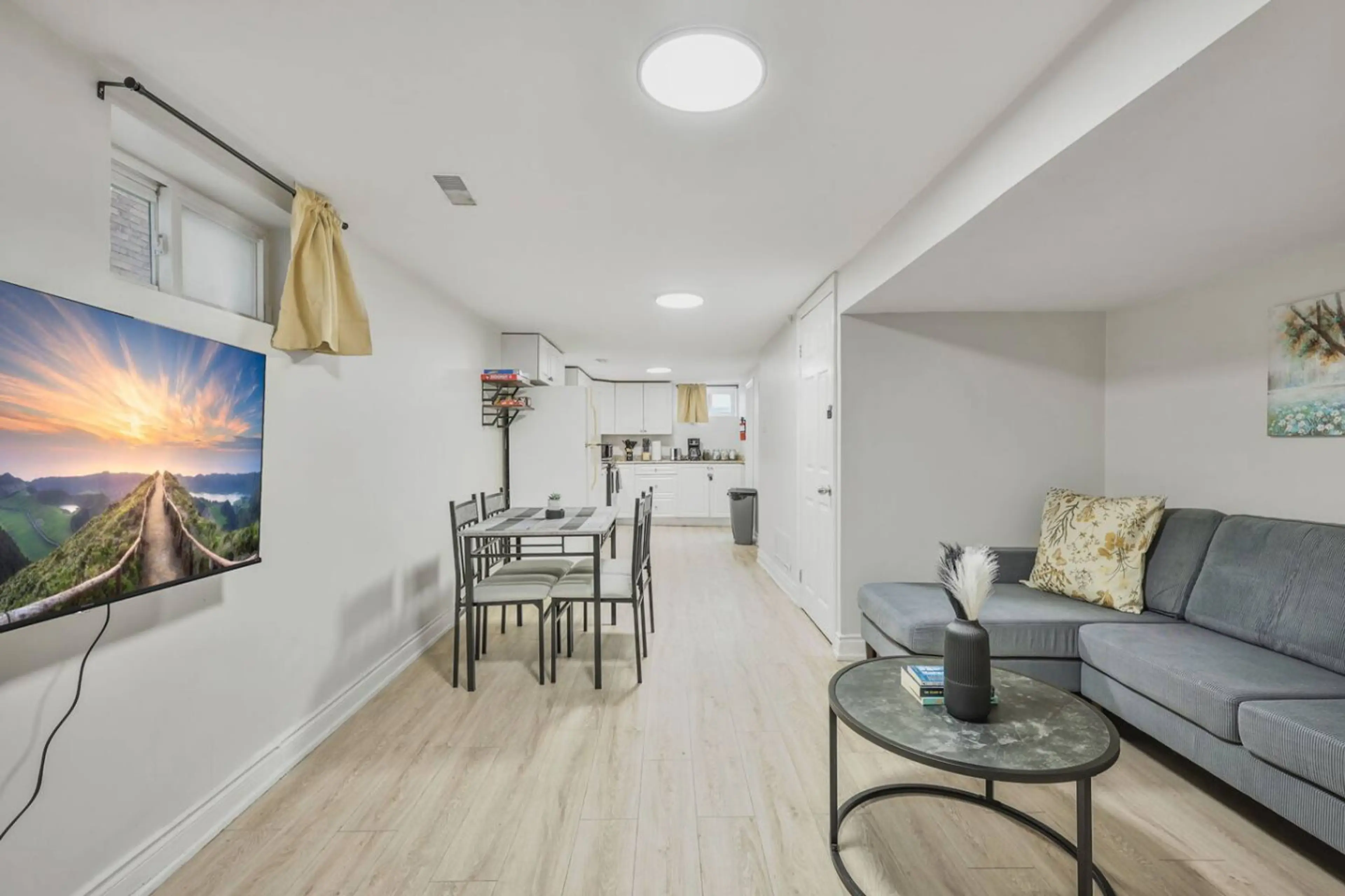 Enjoy a bright open living space with a cozy sectional, dining area, and fully equipped kitchen. Perfect for gathering, relaxing, or sharing meals, this inviting setup makes every stay feel like home.