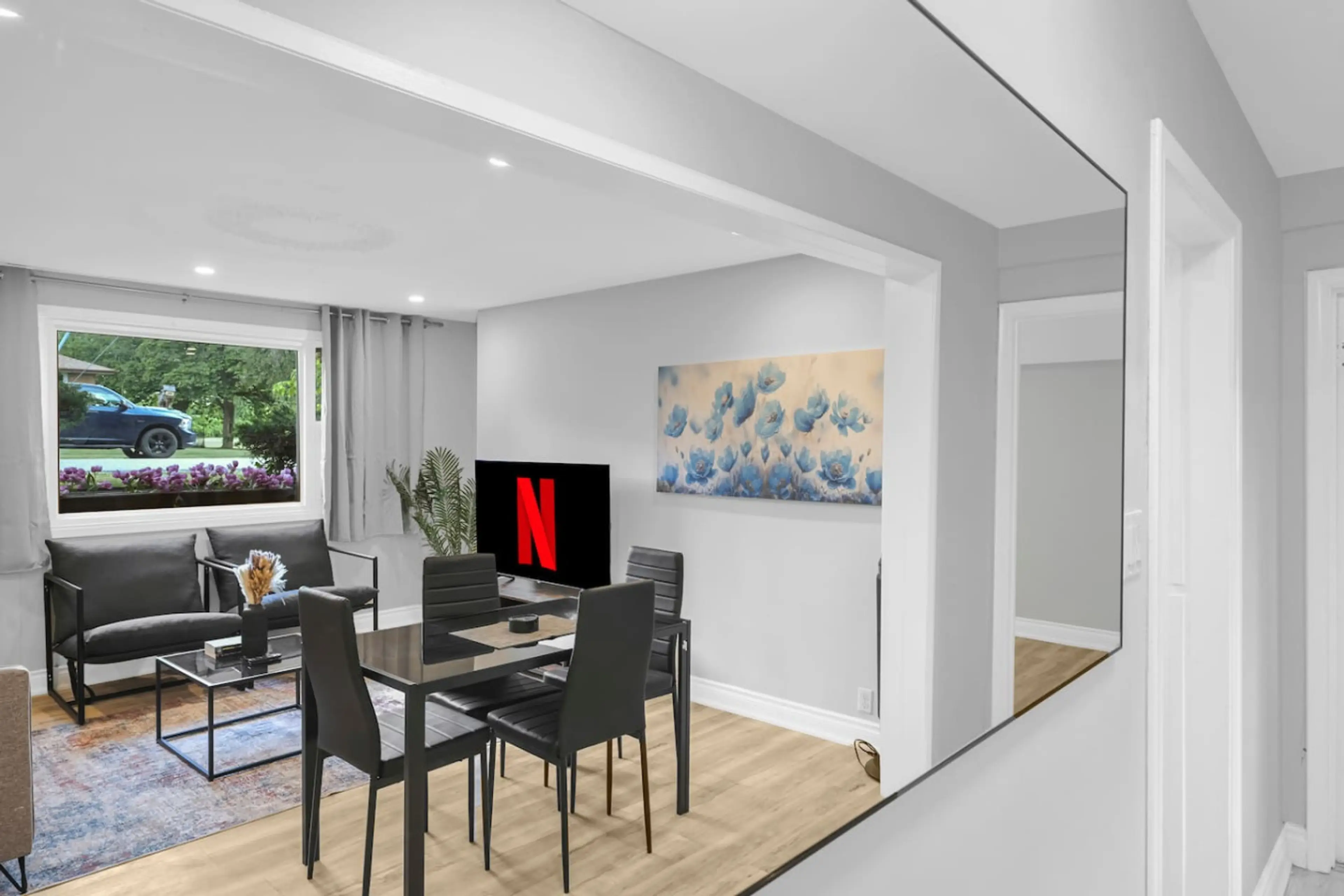 Gather around the stylish dining table for meals or games, seamlessly connected to the comfortable living area. Enjoy flow and function in this beautifully designed open concept space.