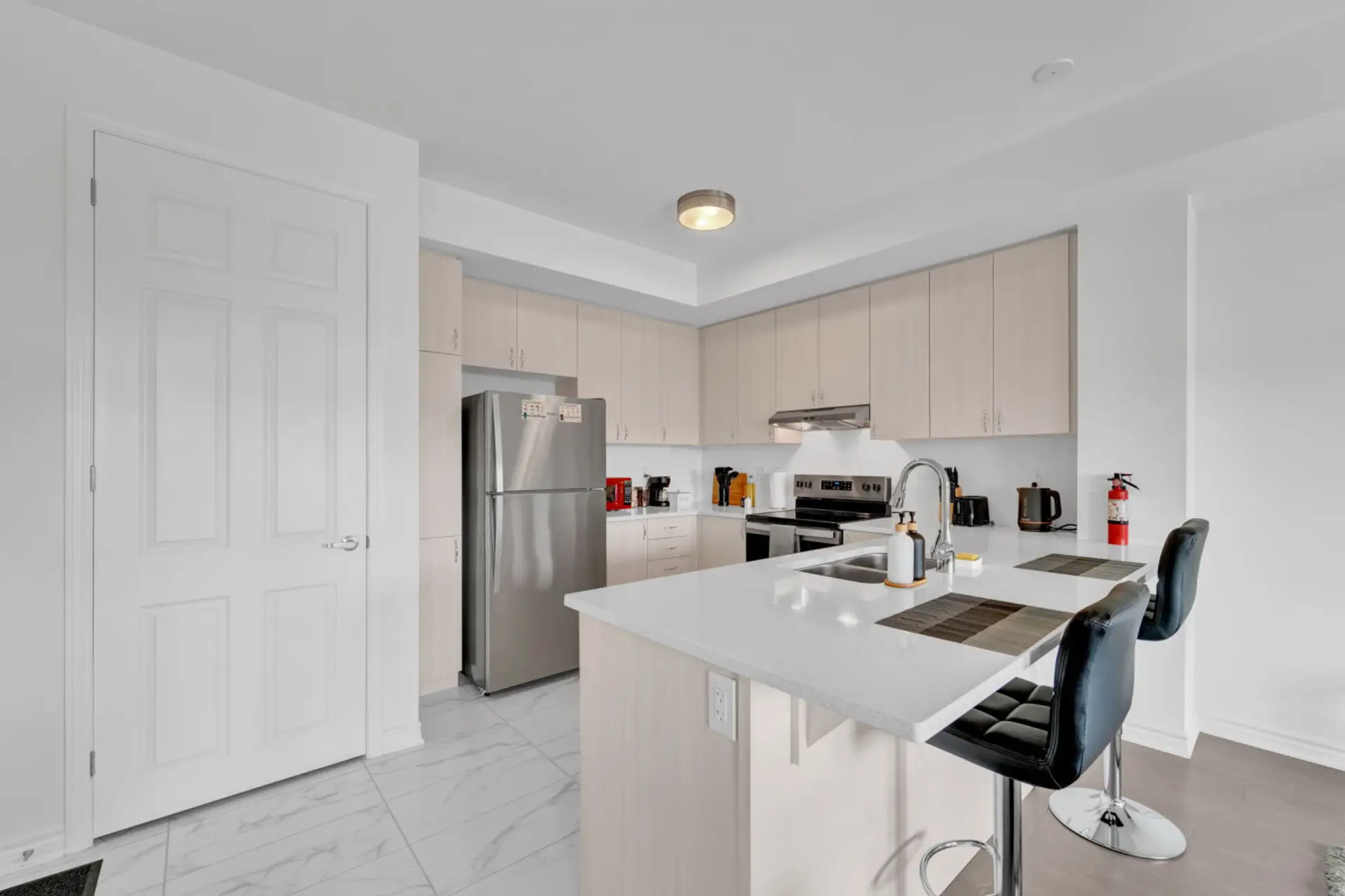 Experience the ease of a fully equipped culinary space. Whether you are brewing your morning coffee or hosting a casual dinner, this bright and functional kitchen provides everything you need for a seamless stay.