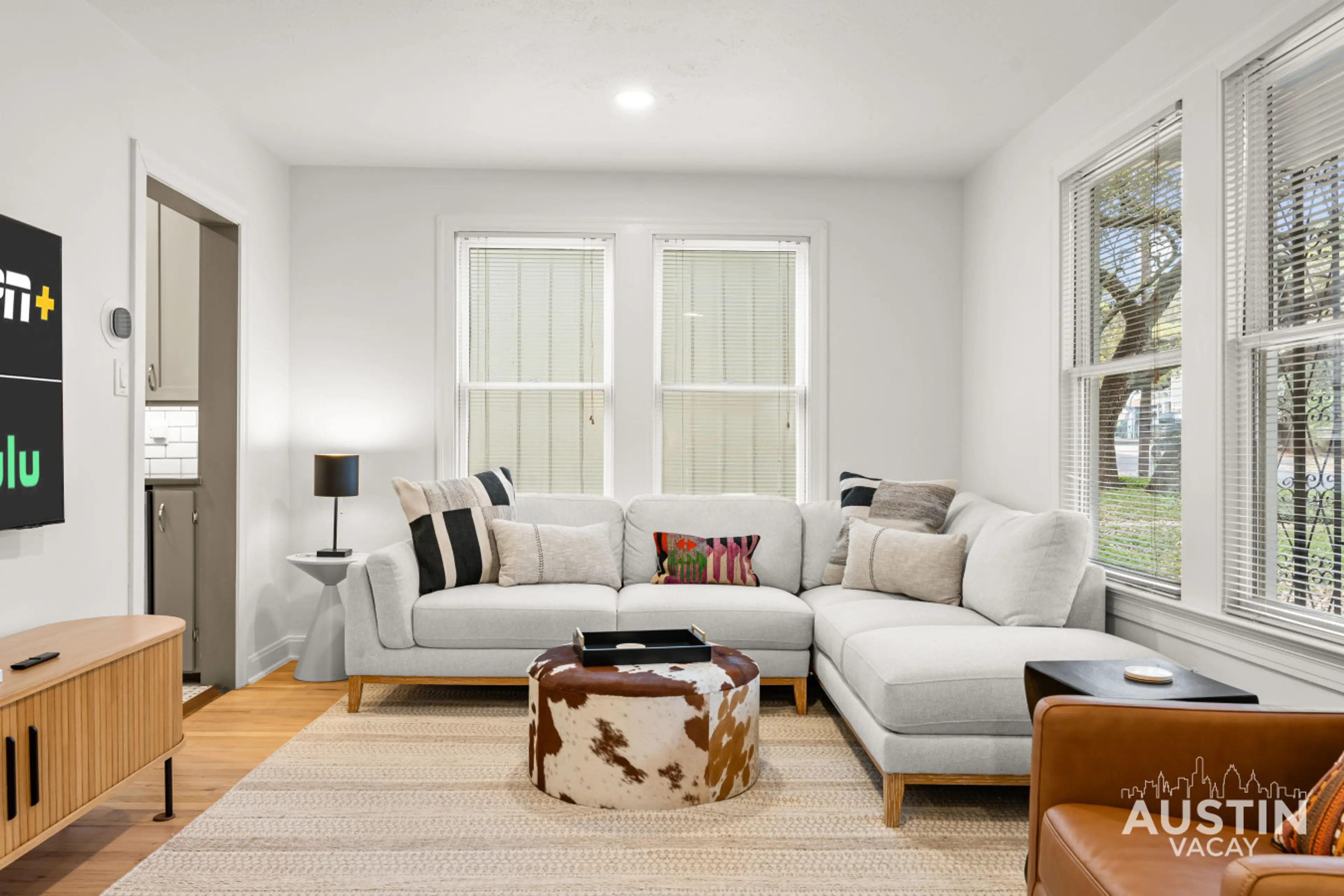 Gather on the oversized sectional with room for the whole crew. Natural light fills the space through large windows.